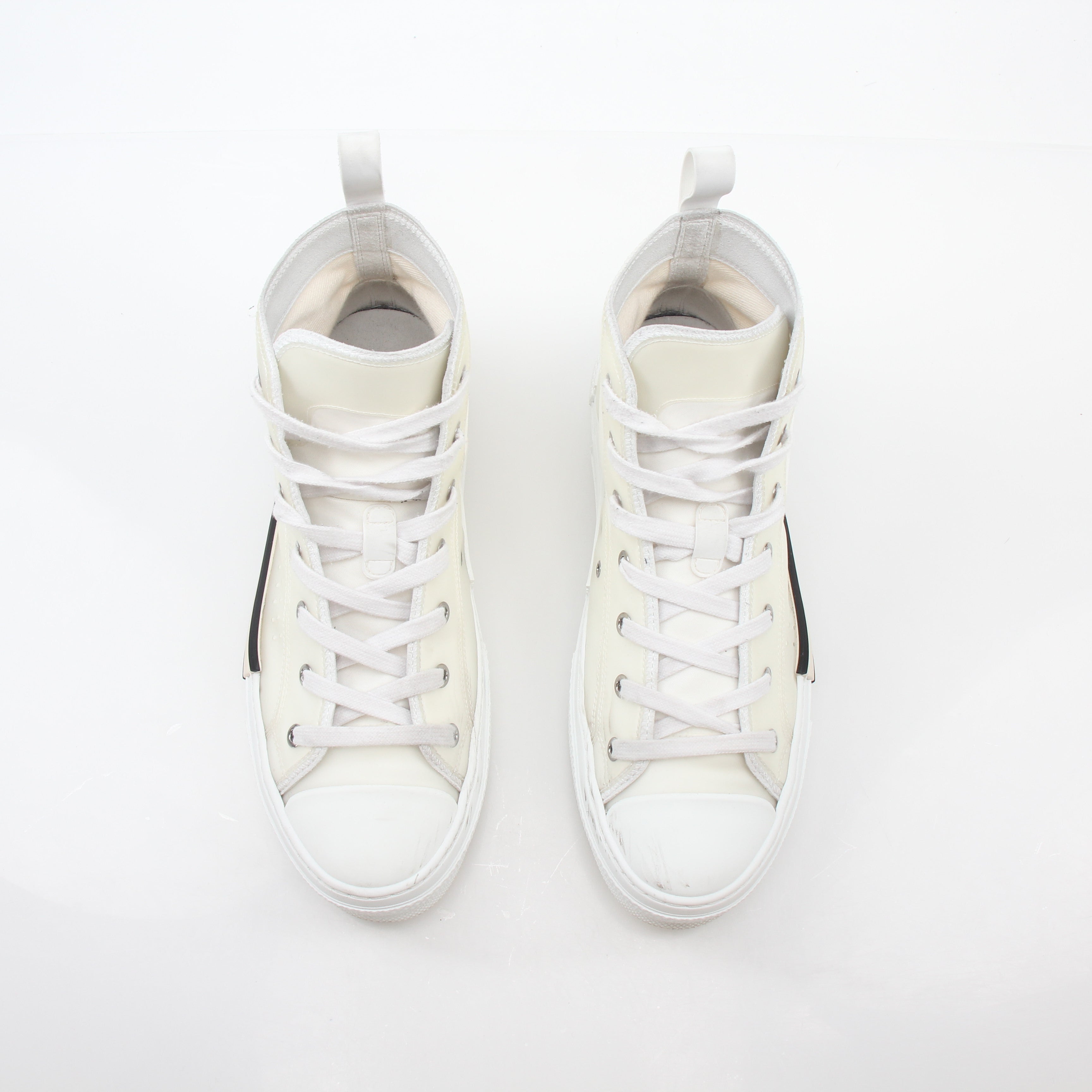 Christian Dior White B23 high-top sneakers with gold accents, showcasing a sleek design and stylish shoe profile.