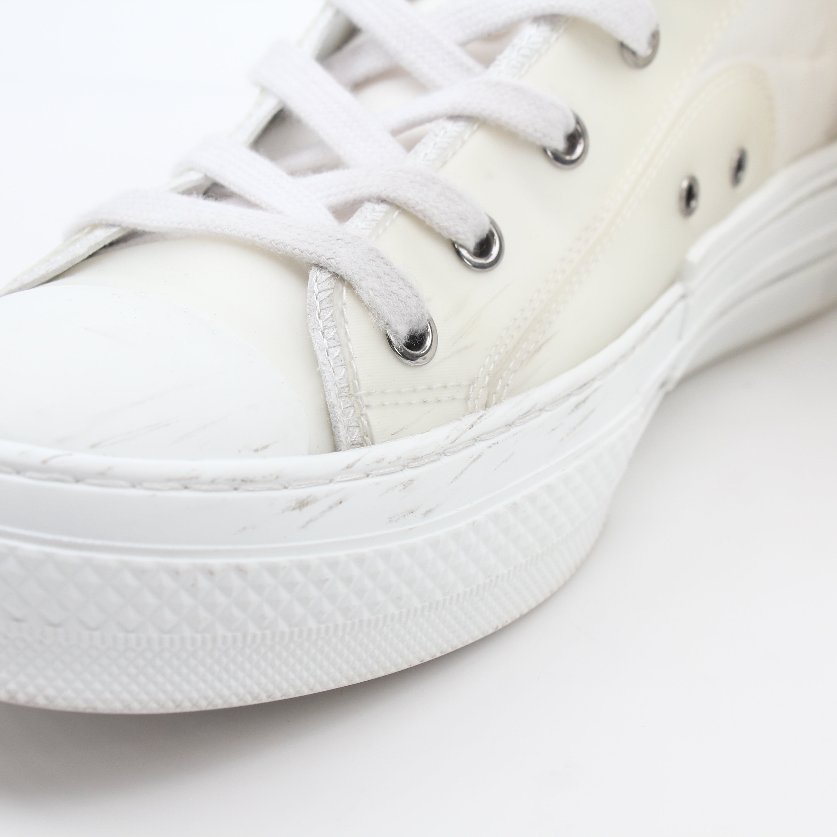Christian Dior White B23 high-top sneakers with gold accents, featuring stylish white leather and casual sneaker design.