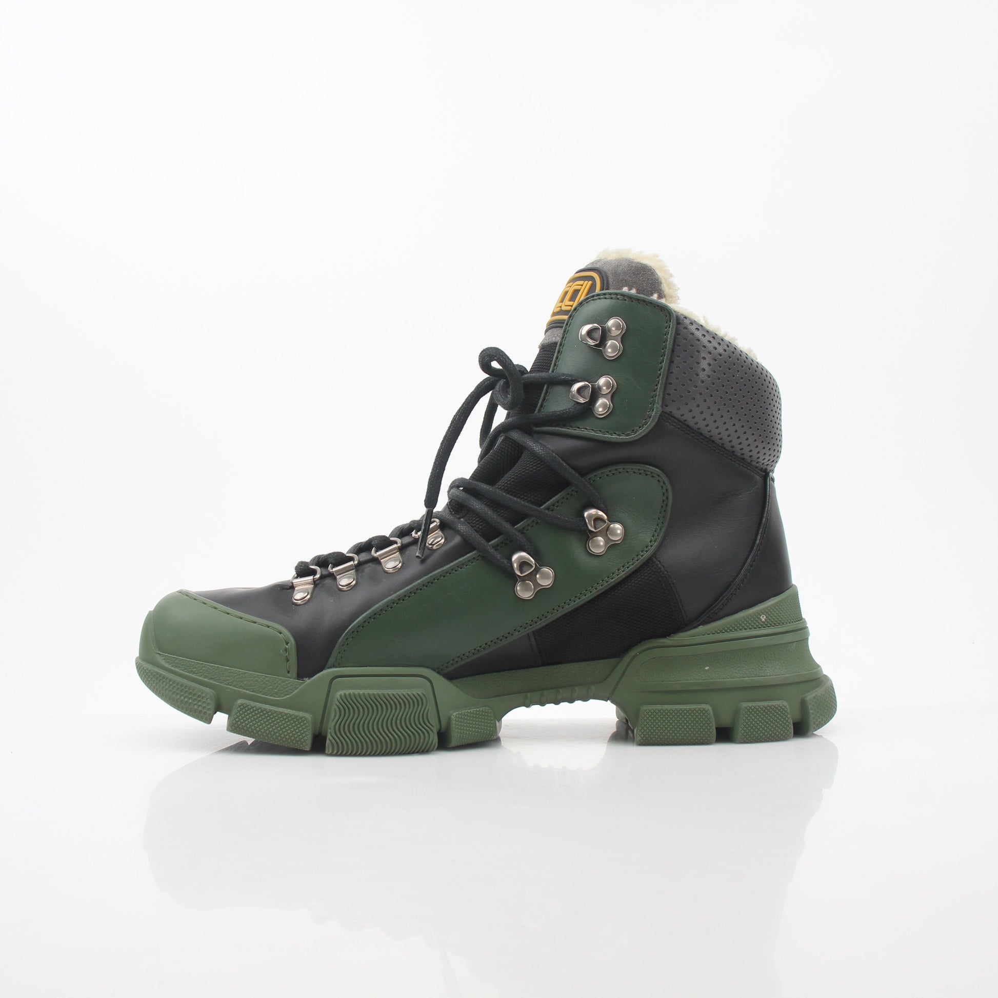 Gucci Green and Black Flashtrek high-top hiking boots in shoes, featuring rugged design and stylish branding.