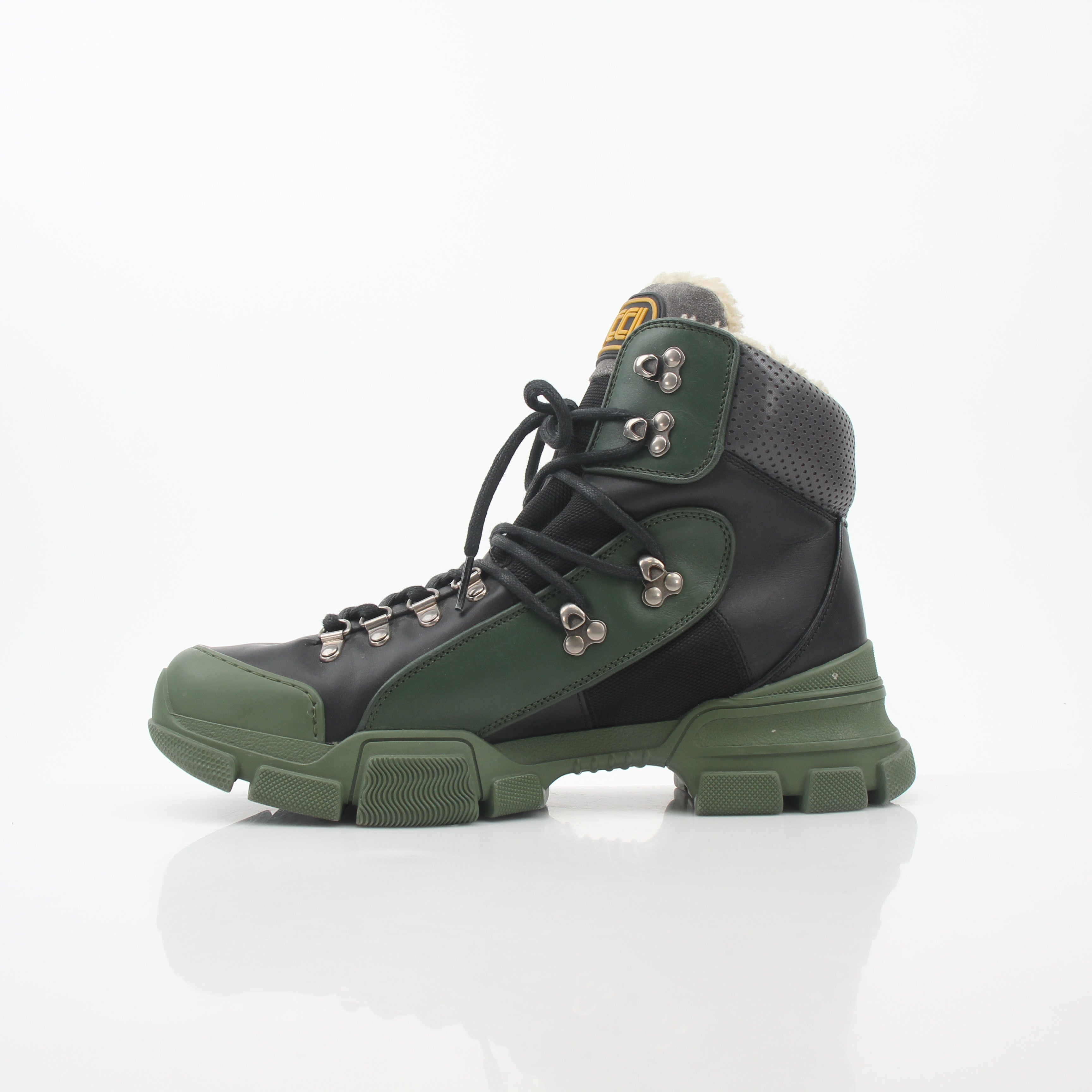 Gucci Green and Black Flashtrek high-top hiking boots in shoes, featuring rugged design and stylish branding.