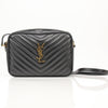 Yves Saint Laurent Lou Matelassé Camera Bag in black, featuring a quilted design and gold hardware, displayed on a neutral background.