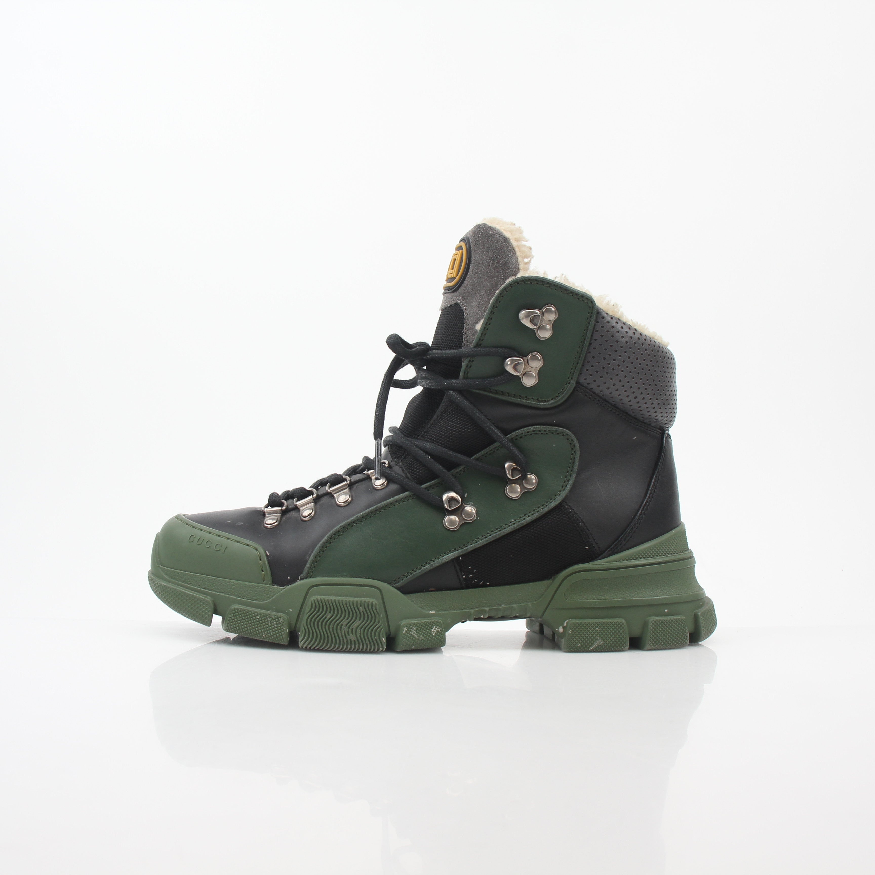 Gucci green and black Flashtrek high-top hiking shoes with rugged sole and logo details, designed for outdoor adventures.