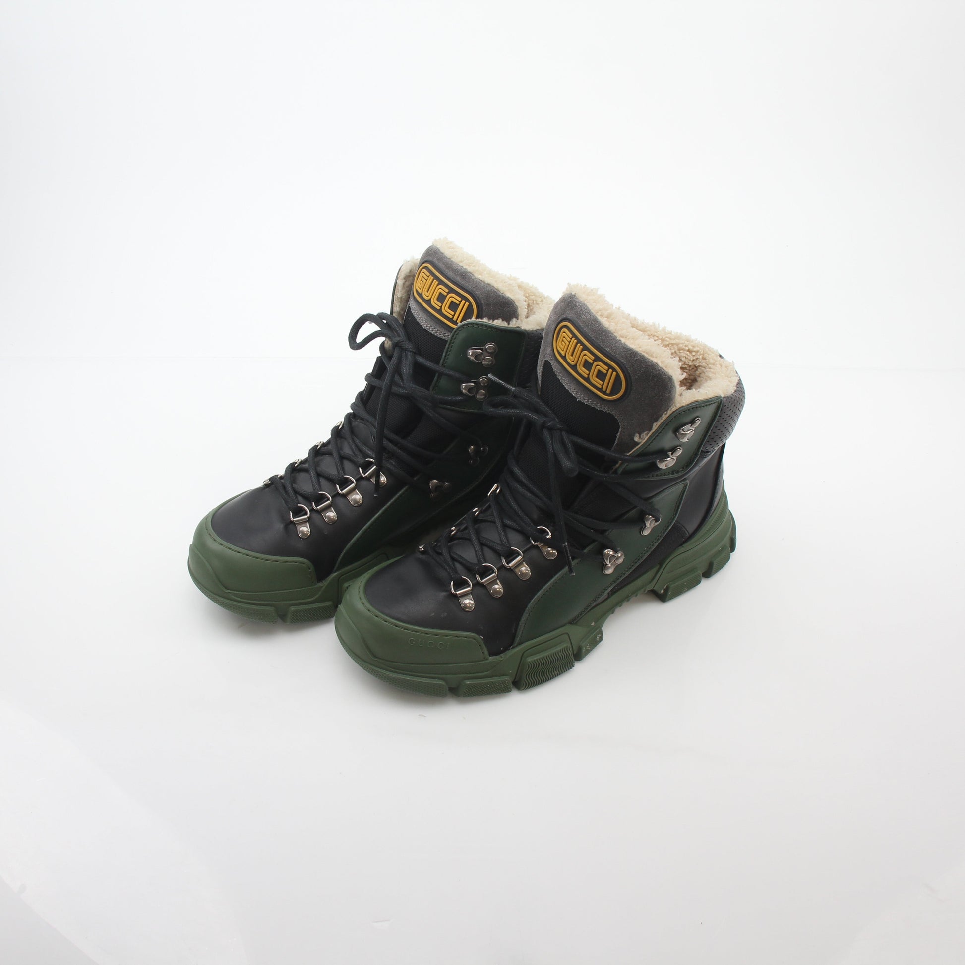 Gold & Beyond Gucci green and black Flashtrek high-top hiking shoes with rugged soles and stylish design.