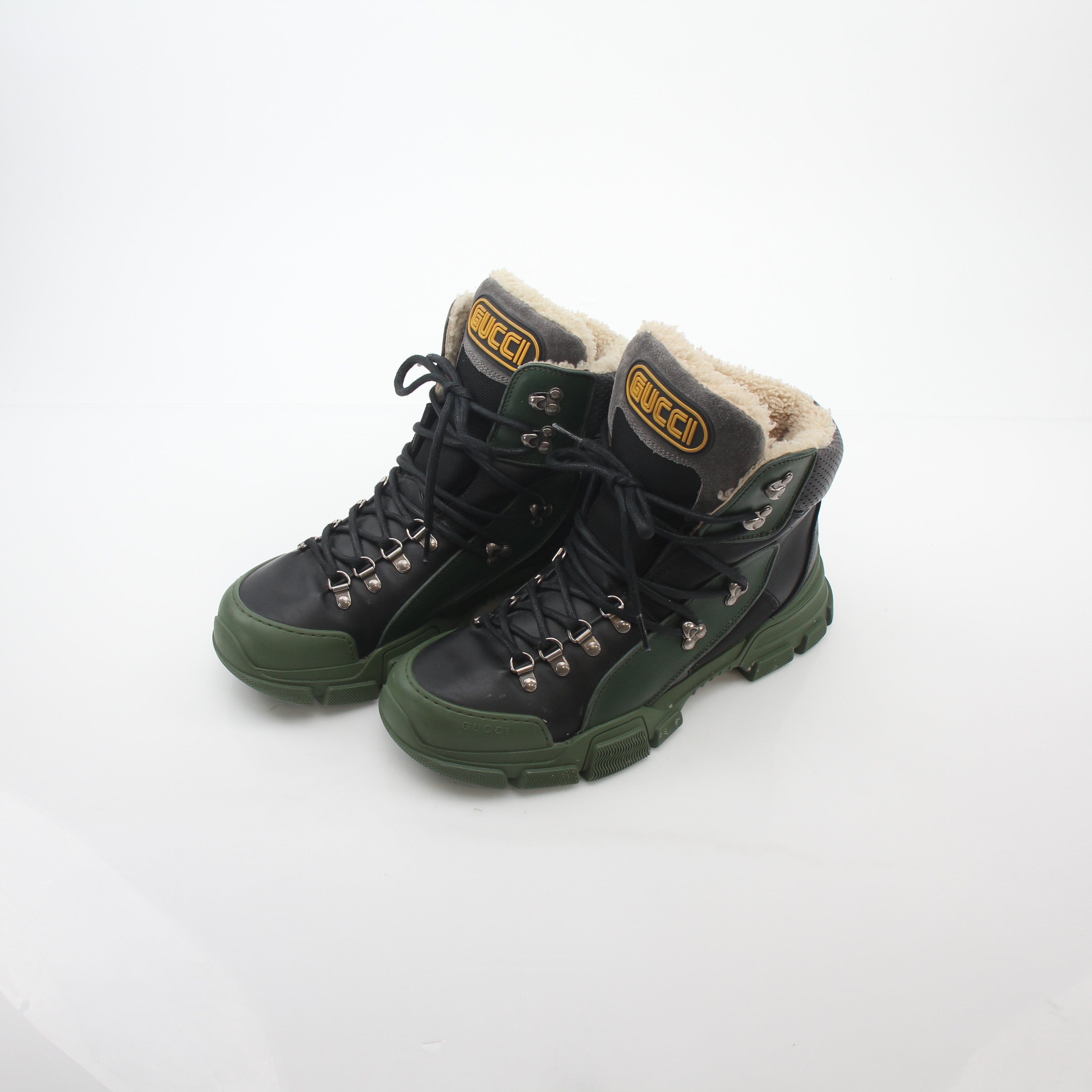 Gold & Beyond Gucci green and black Flashtrek high-top hiking shoes with rugged soles and stylish design.