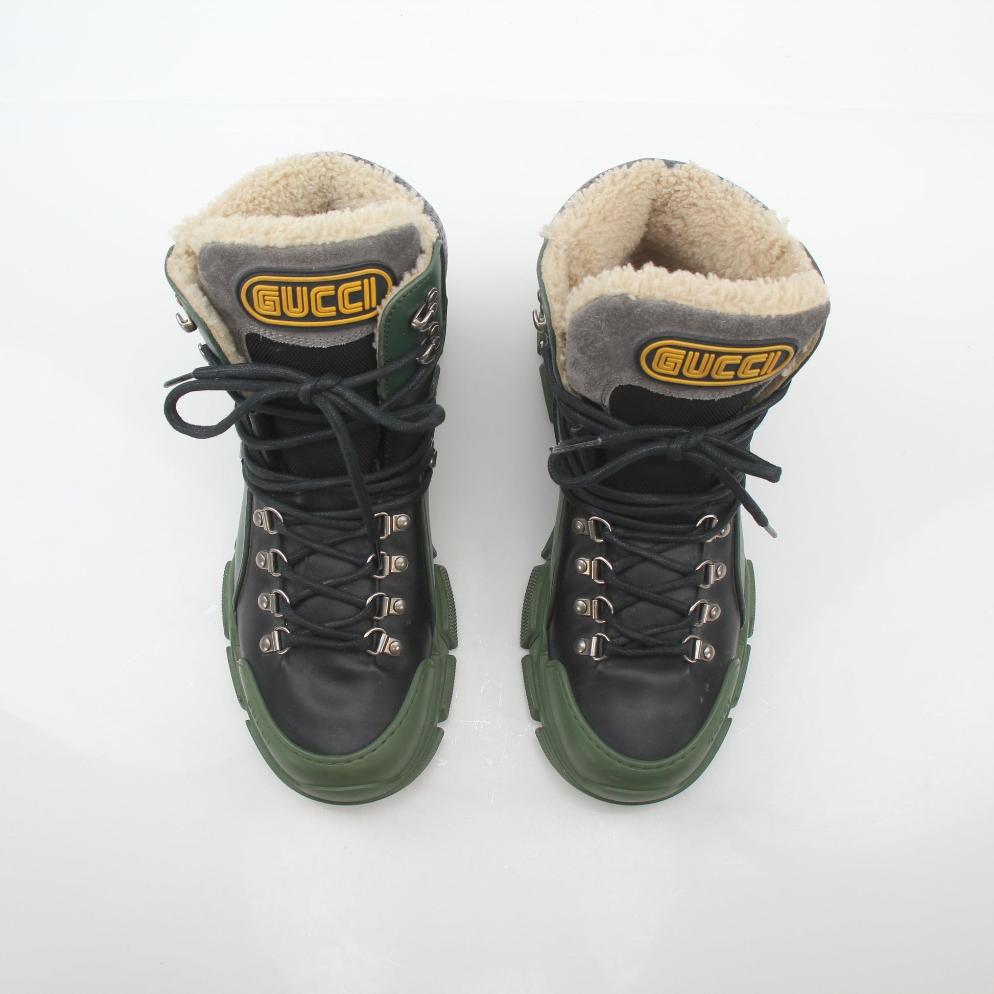 Green and black Gucci Flashtrek high-top hiking shoes with rugged design and durable sole from Gold & Beyond.