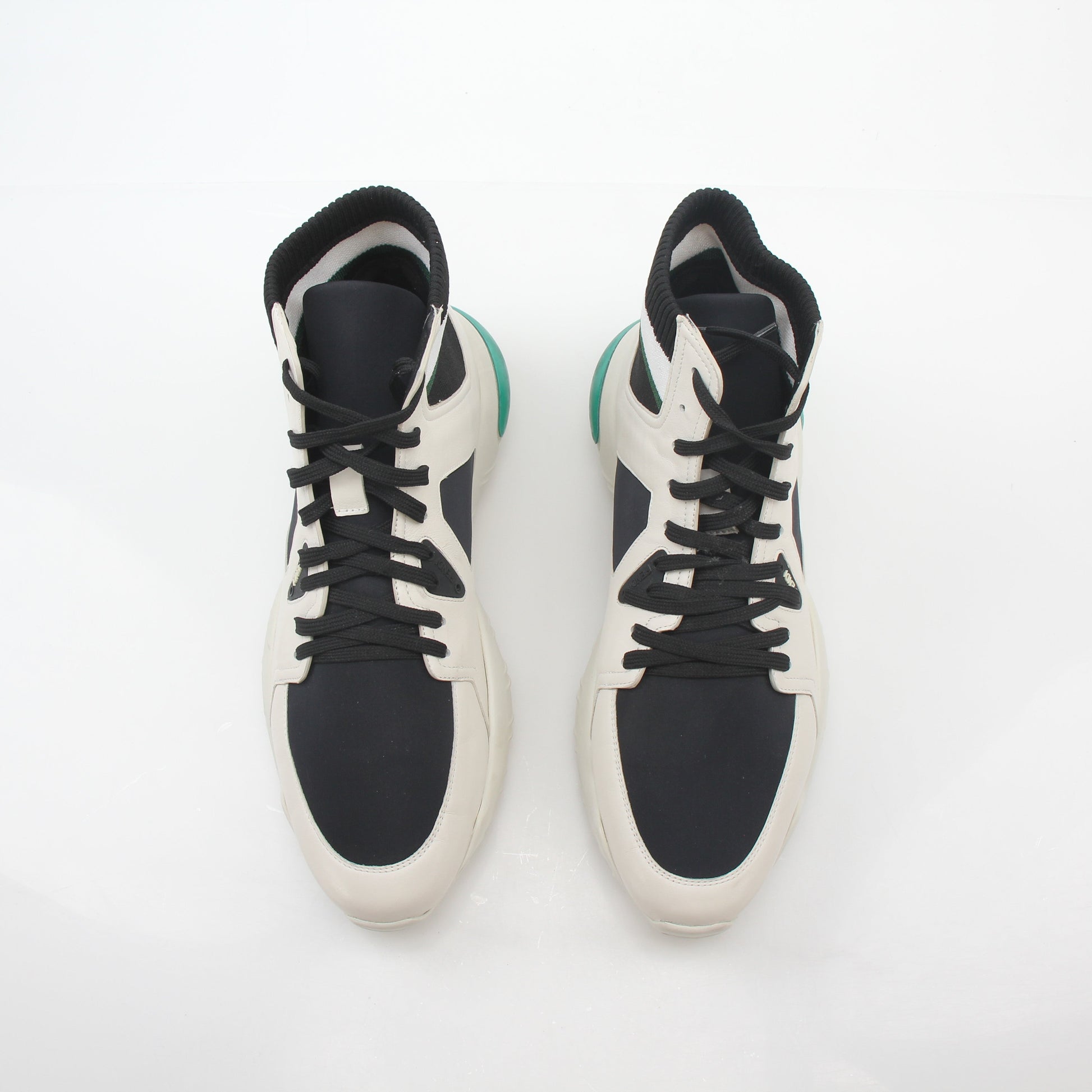 Gold & Beyond Fendi high-top sneakers in white, black, and green with stylish design and detailed branding visible.