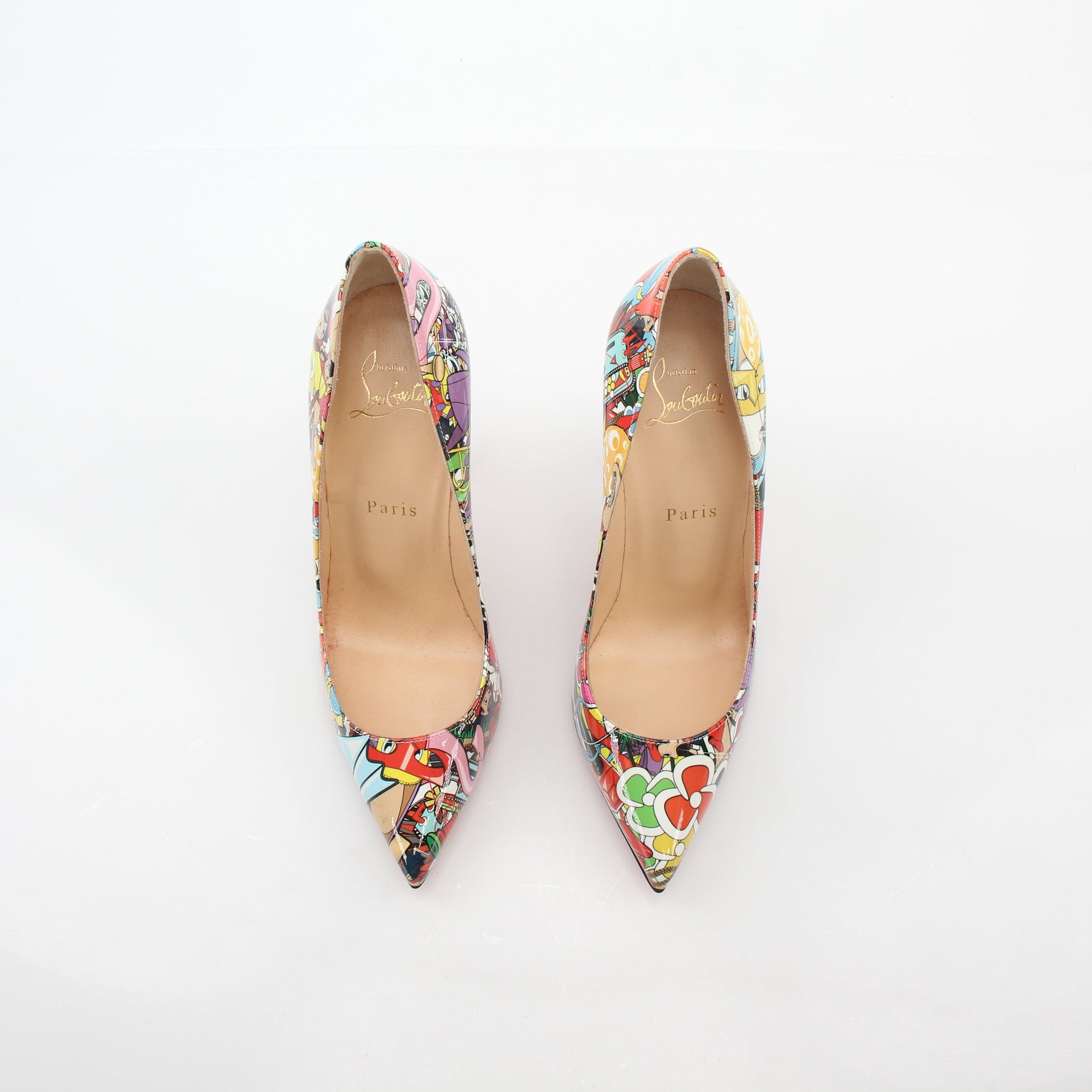 Christian Louboutin Multicolor Super Loubi Pigalle Follies 100 heels with pointed toes and signature red soles, displayed on a neutral background.