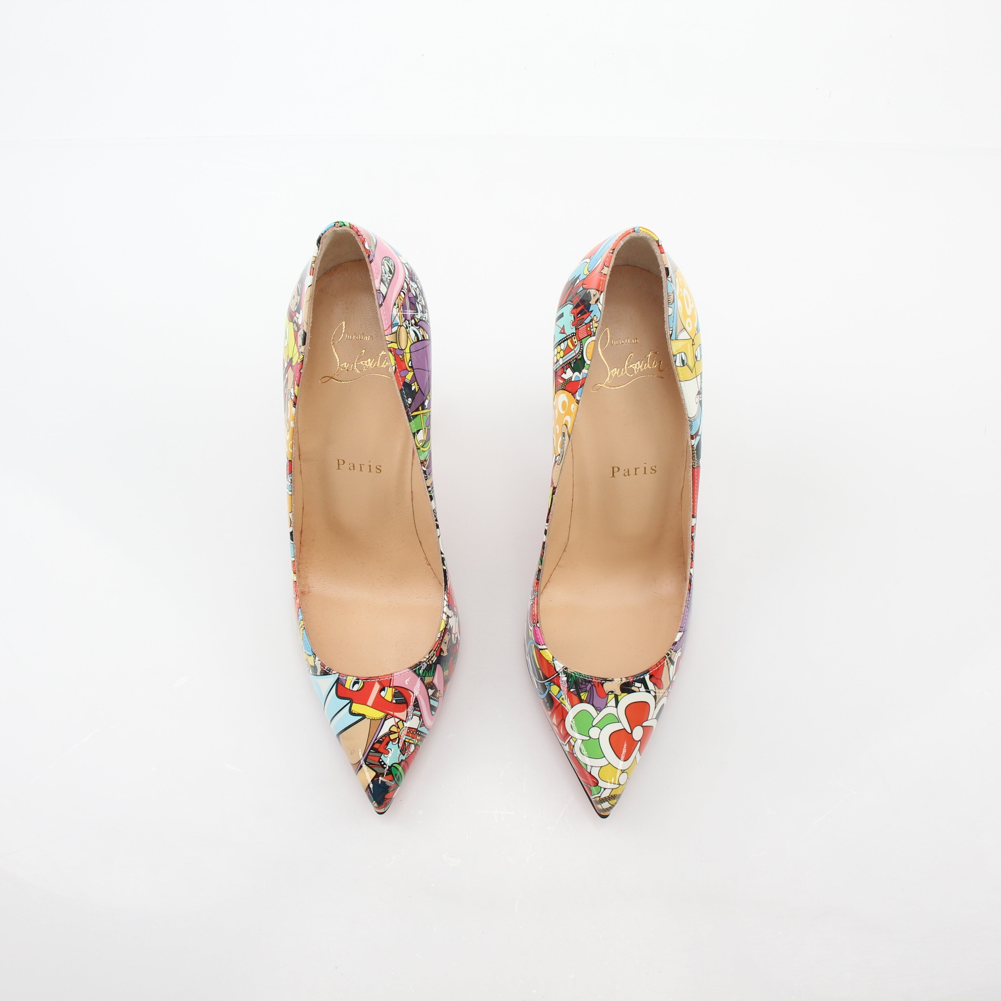 Christian Louboutin Multicolor Super Loubi Pigalle Follies 100 heels with pointed toes and signature red soles, displayed on a neutral background.