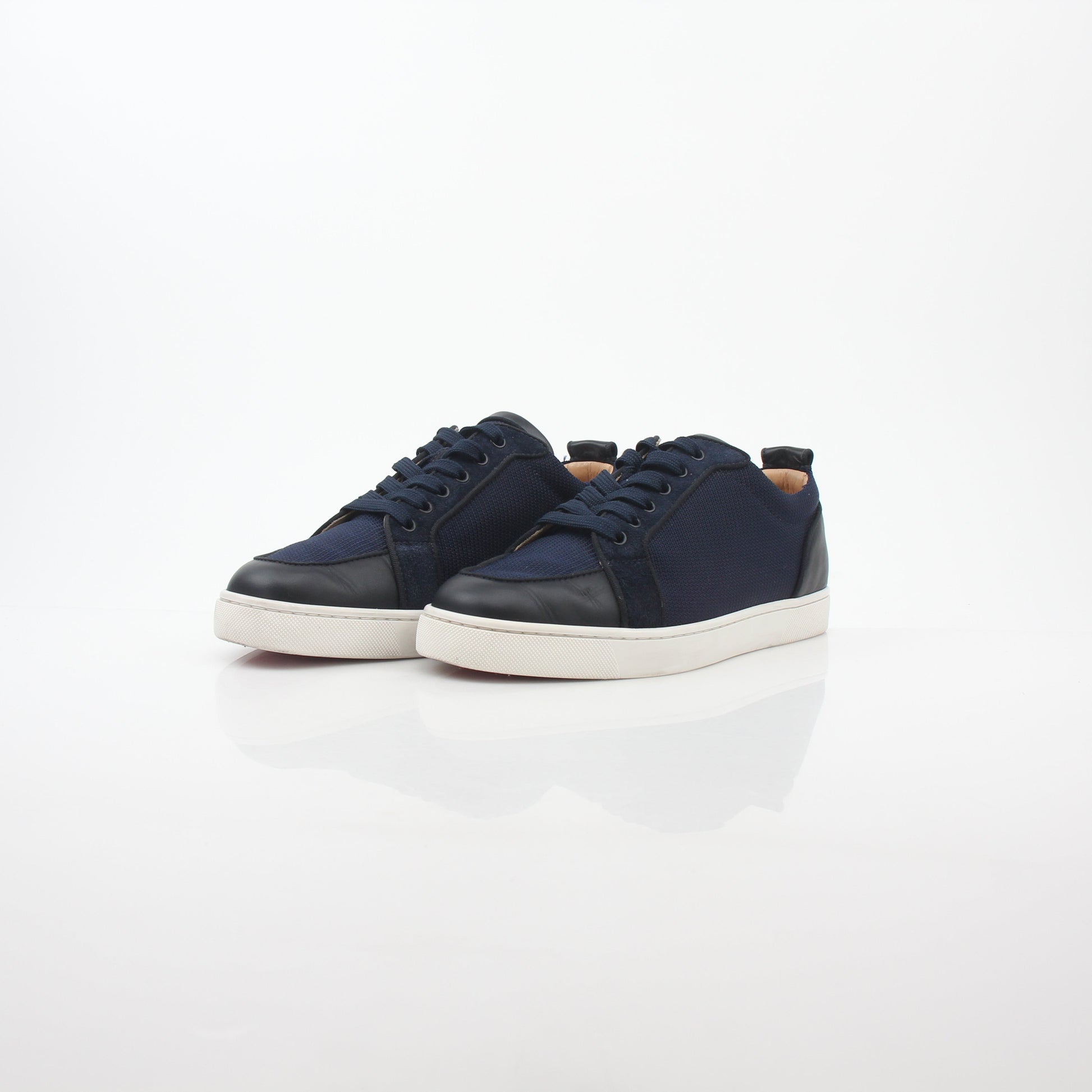 Christian Louboutin navy Rantulow Orlato low-top sneakers with red sole and stylish design, featured in this image.