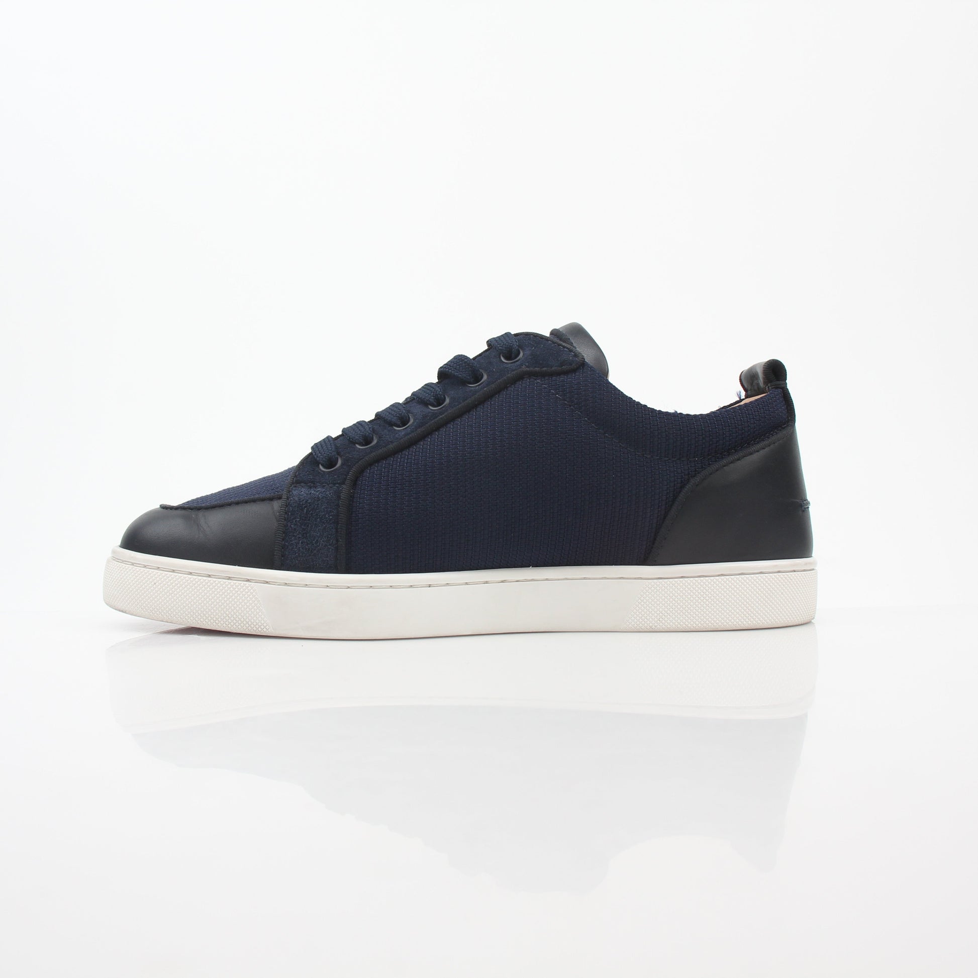 Christian Louboutin navy Rantulow Orlato low-top sneakers with signature red soles and sleek design, displayed on a neutral background.