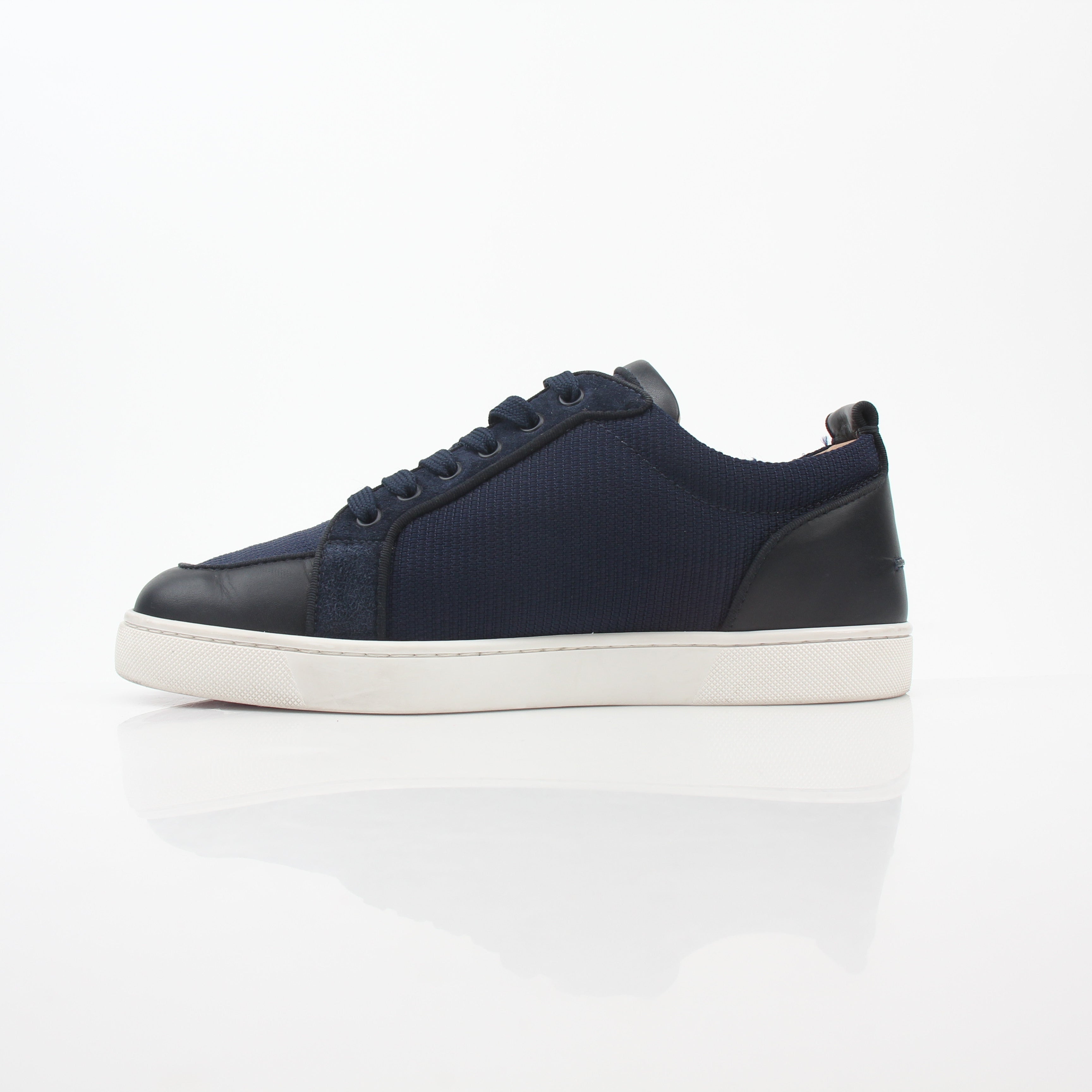 Christian Louboutin navy Rantulow Orlato low-top sneakers with signature red soles and sleek design, displayed on a neutral background.