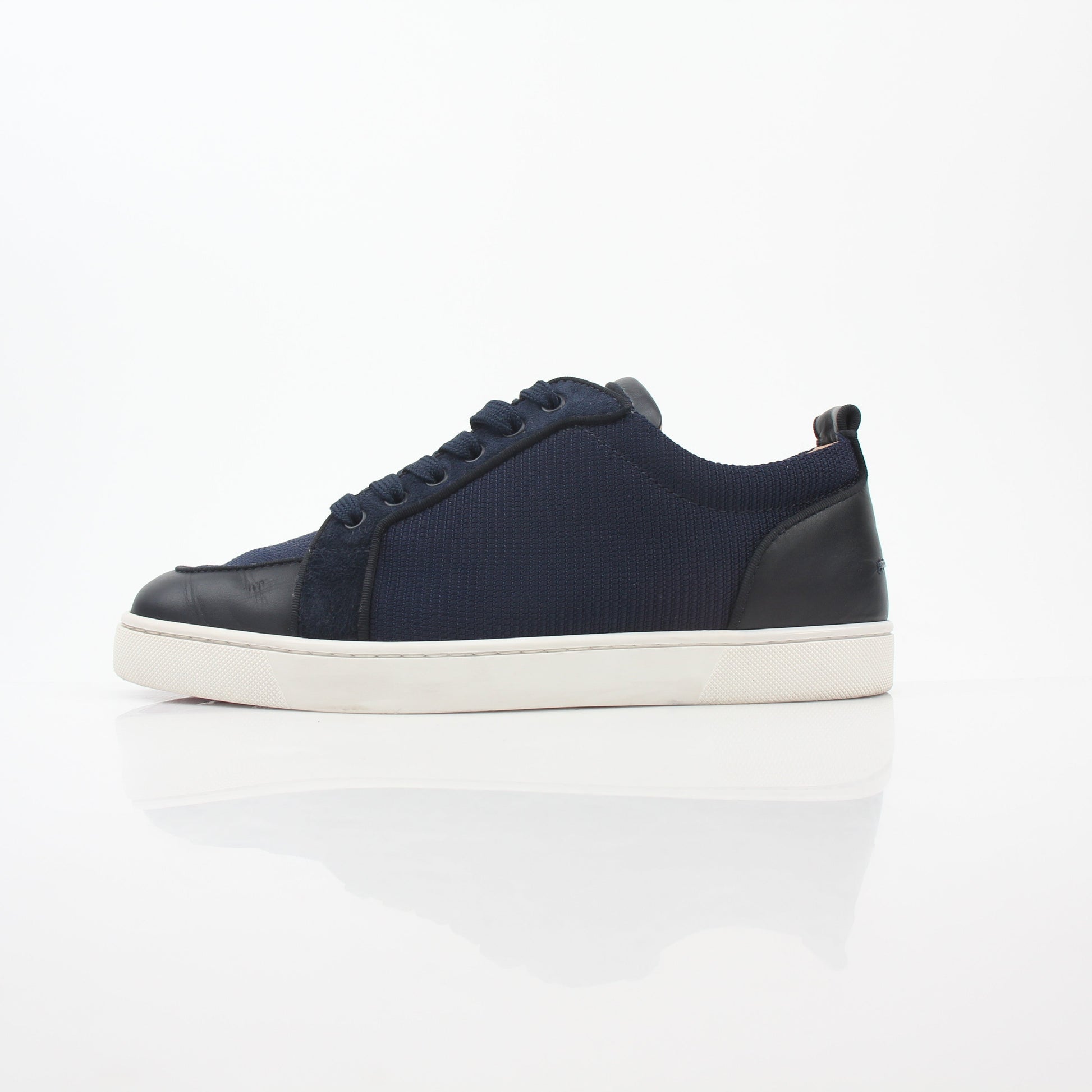 Christian Louboutin Navy Rantulow Orlato low-top sneakers with red sole and sleek design, displayed on a white background.