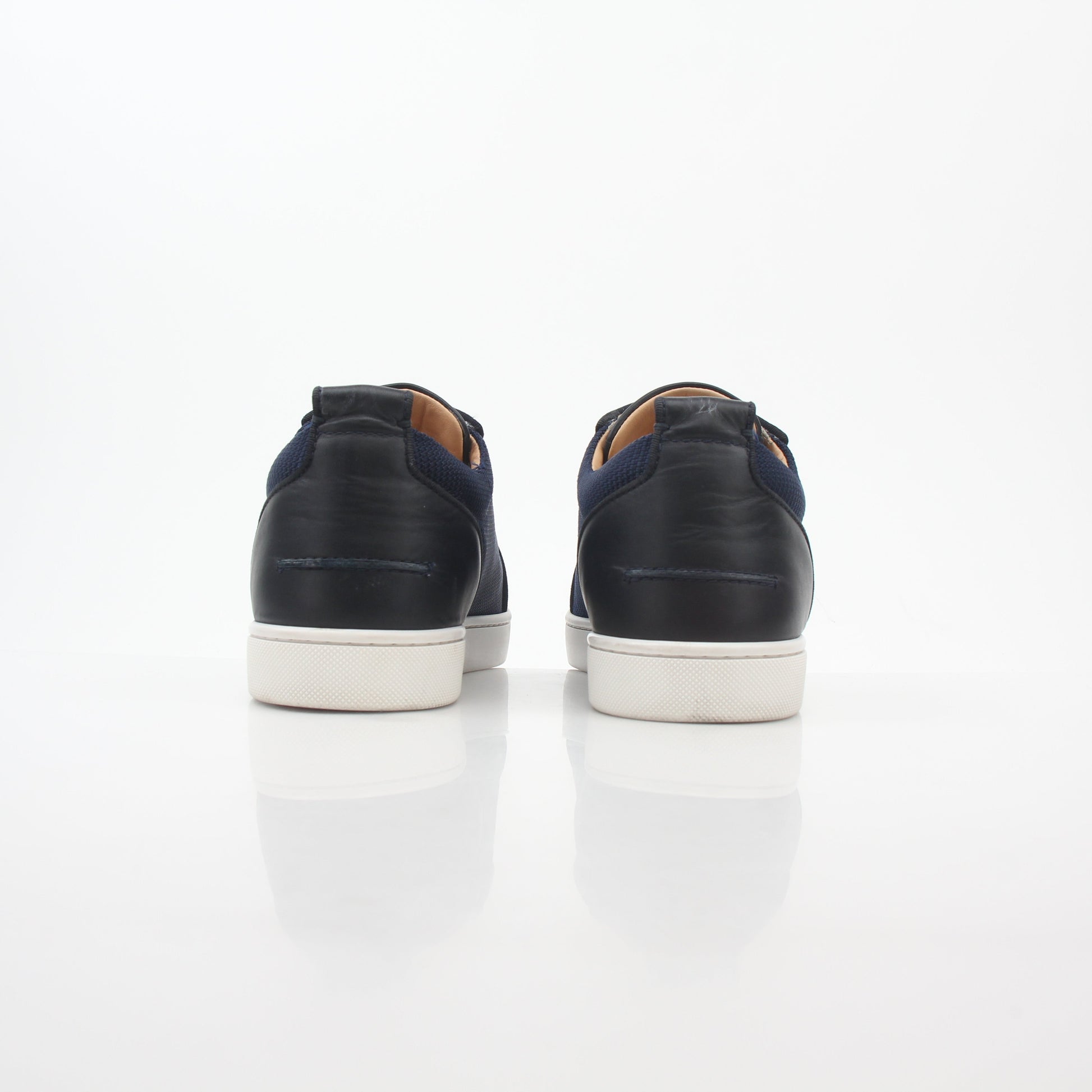 Christian Louboutin Navy Rantulow Orlato low-top sneakers with gold accents, showcasing sleek design and iconic branding.