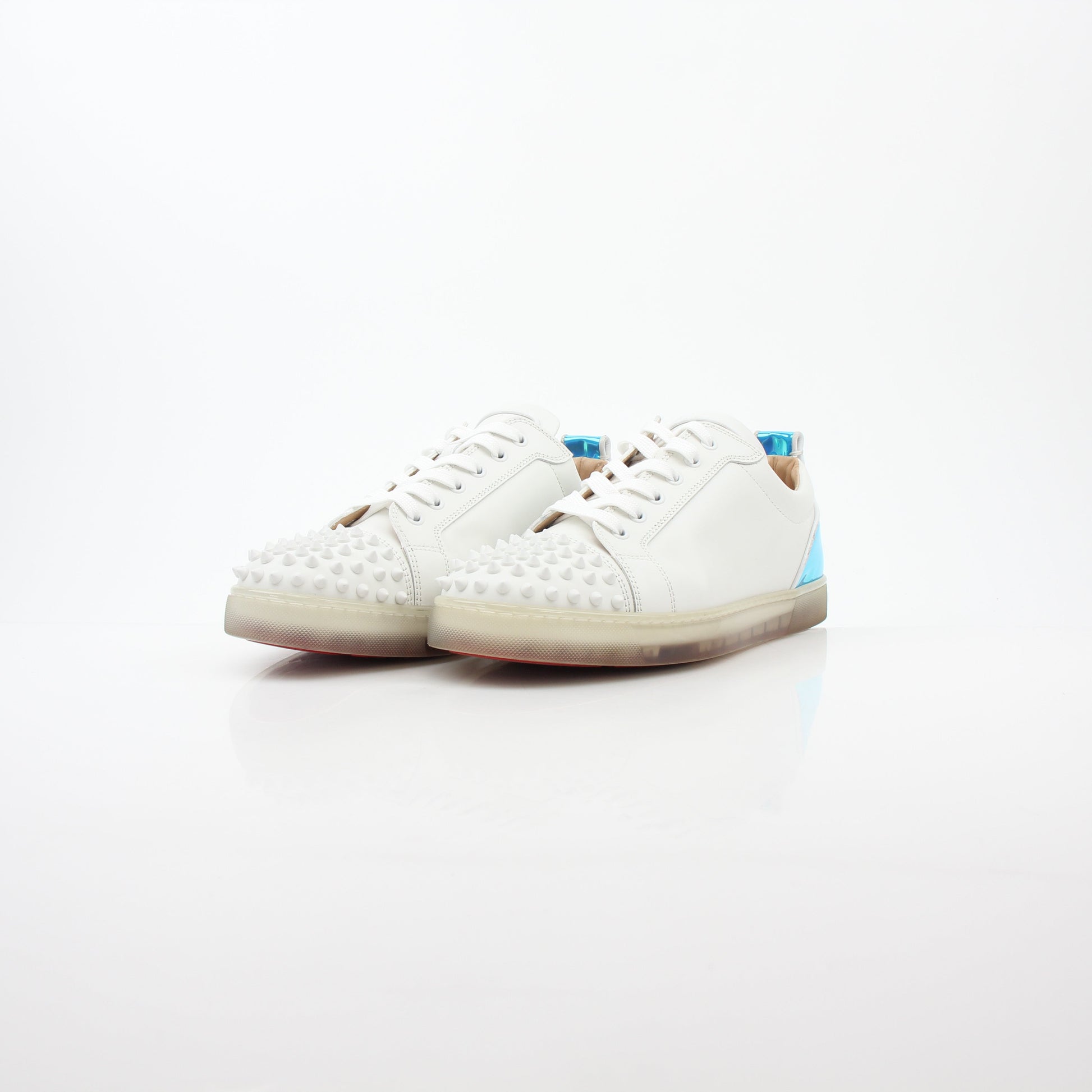 Christian Louboutin White Varsijunior Spikes 2 low-top sneakers with studded details and white leather, displayed on a plain background.