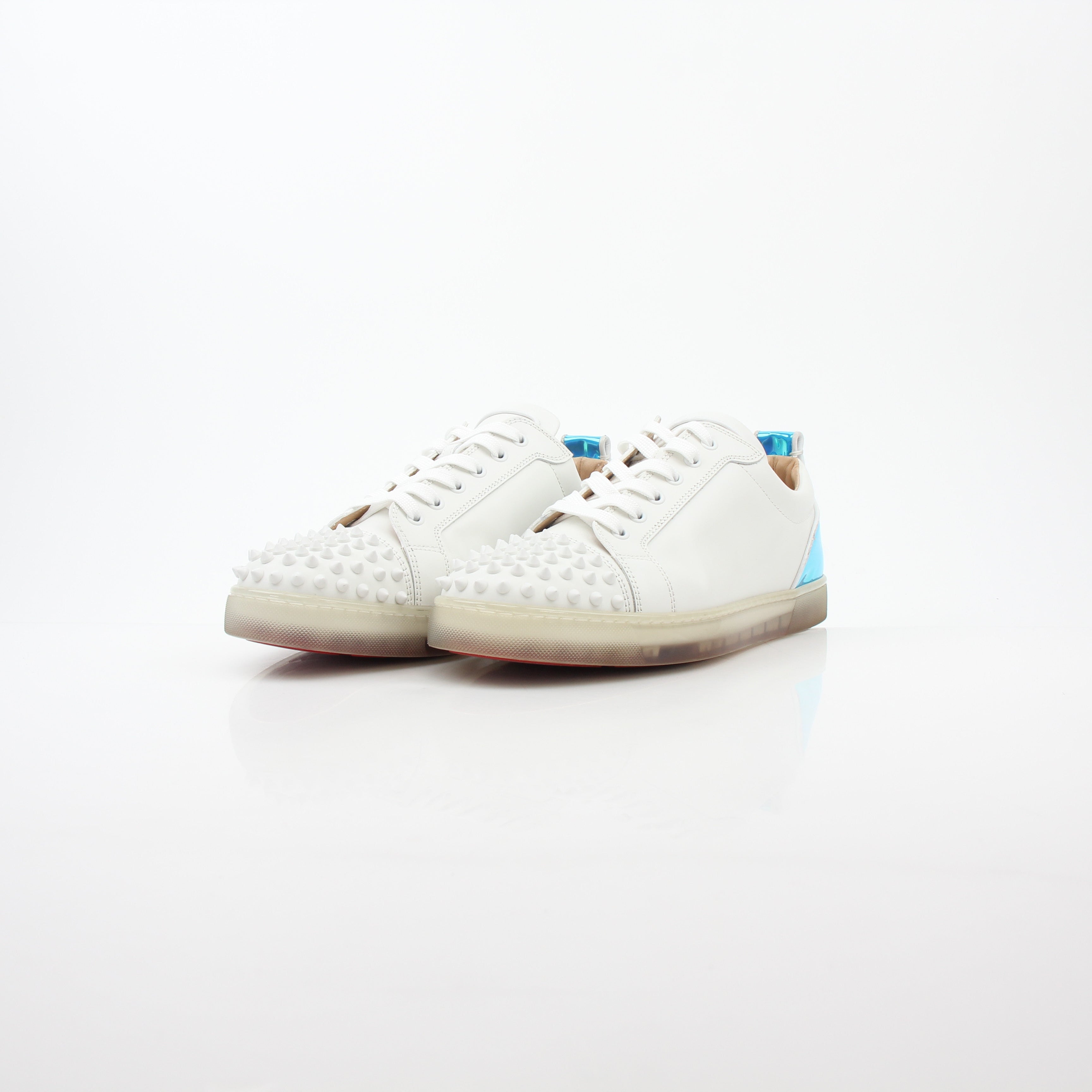 Christian Louboutin White Varsijunior Spikes 2 low-top sneakers with studded details and white leather, displayed on a plain background.