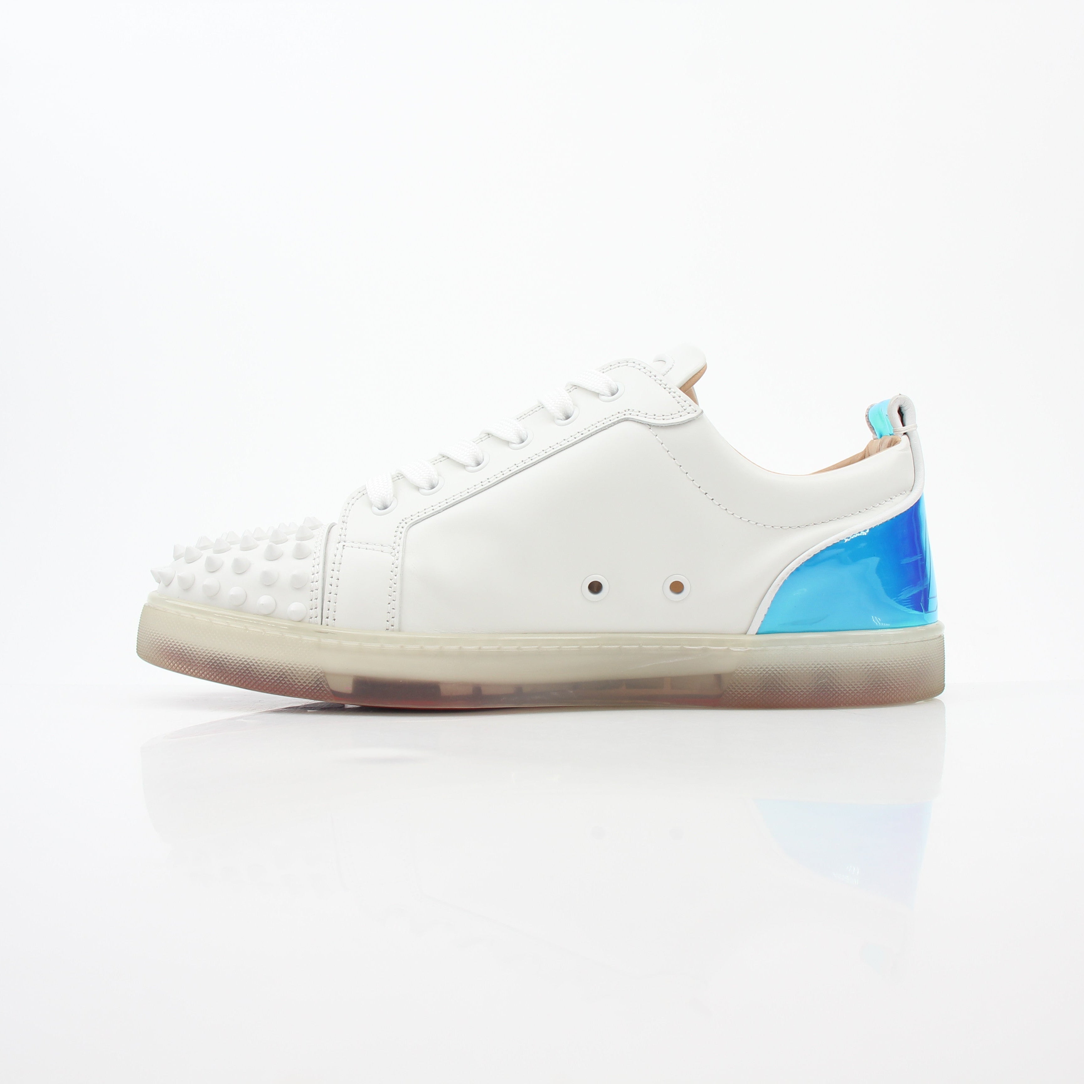 Christian Louboutin White Varsijunior Spikes 2 low-top sneakers with black spikes and white leather, displayed on a clean background.