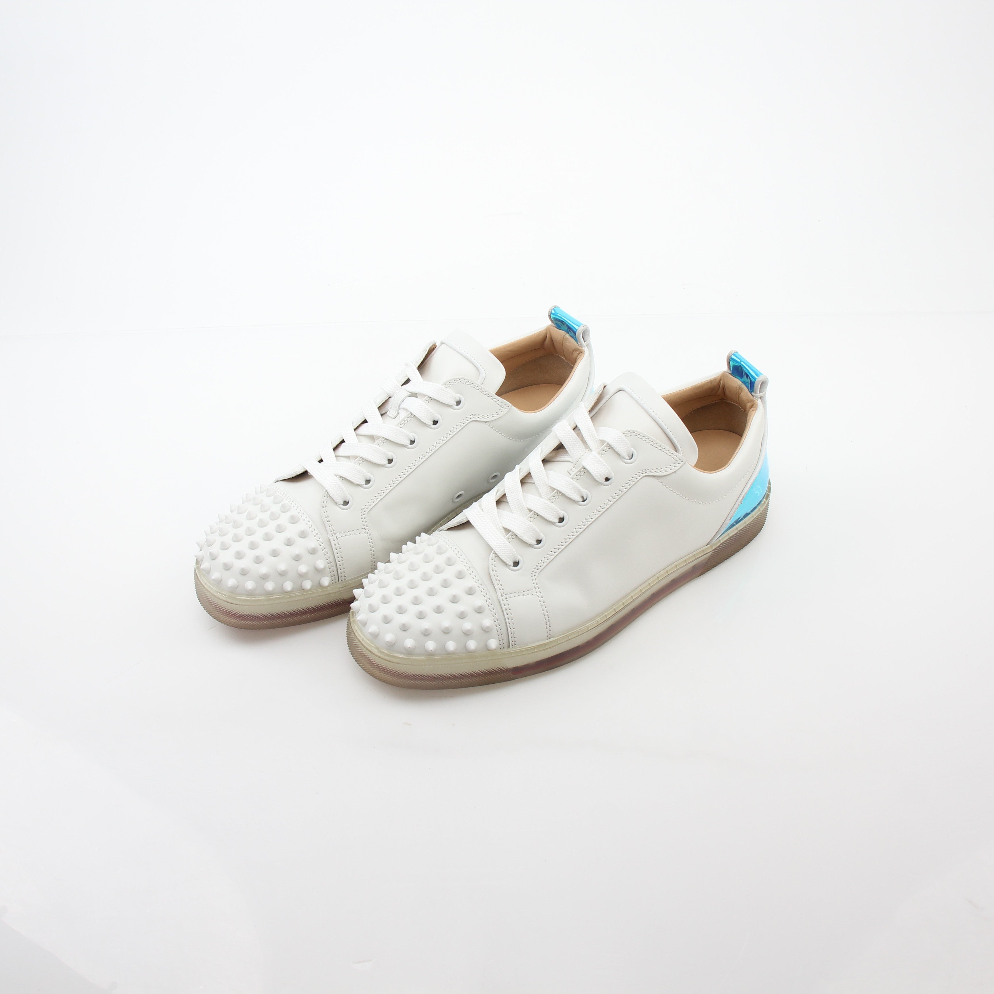 Christian Louboutin Varsijunior Spikes 2 white low-top sneakers with black accents and studded design, displayed on a plain background.