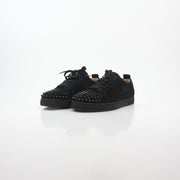 Black Christian Louboutin Louis Junior Spikes low-top sneakers with signature spikes and sleek design, shown from the side.