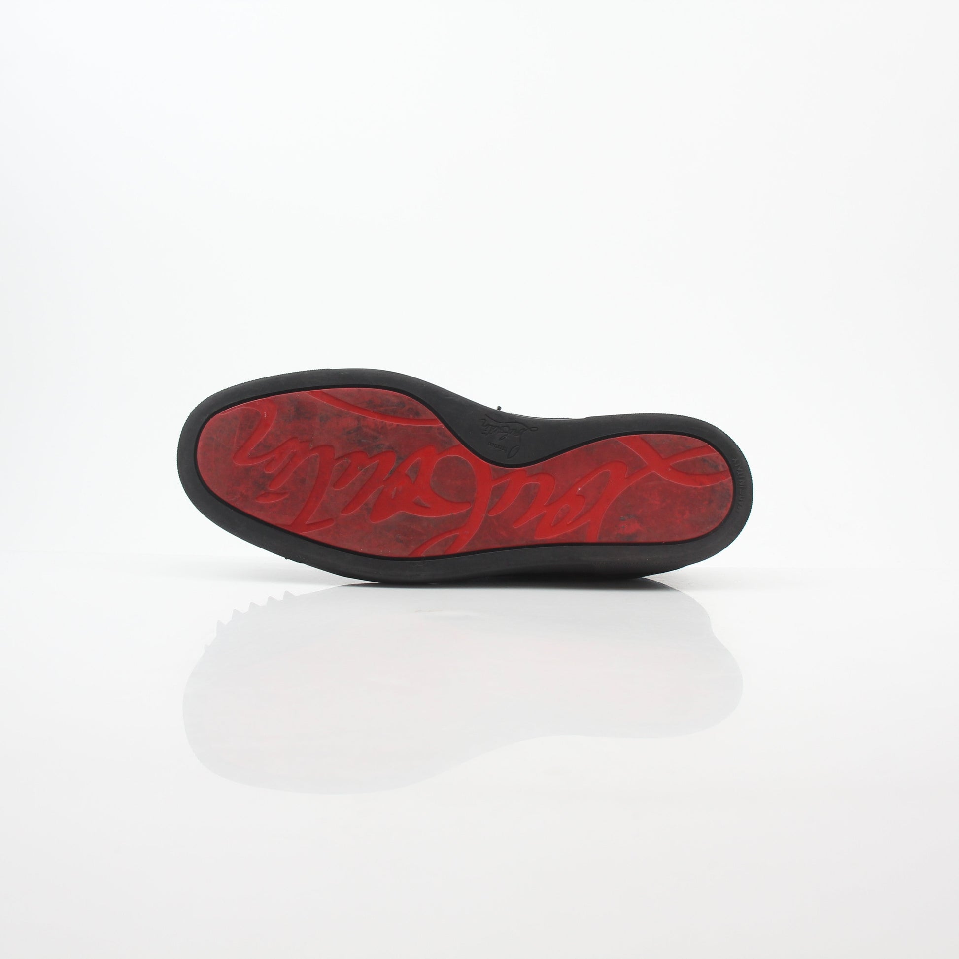 Black Christian Louboutin Louis Junior Spikes low-top sneakers with gold accents and spikes, displayed on a white background.