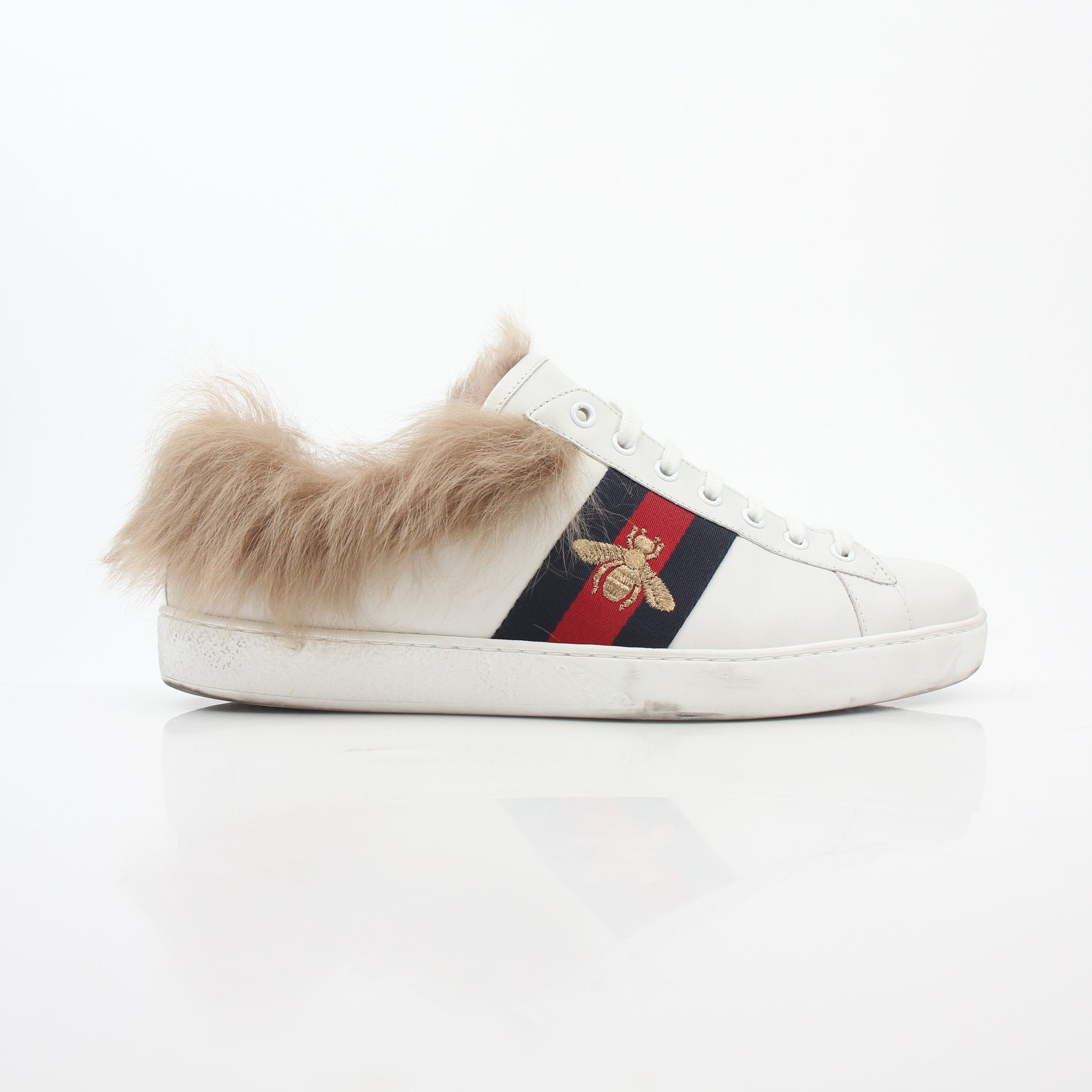 Gucci White Ace embroidered bee fur low-top sneakers with gold accents and detailed embroidery, displayed on a plain background.