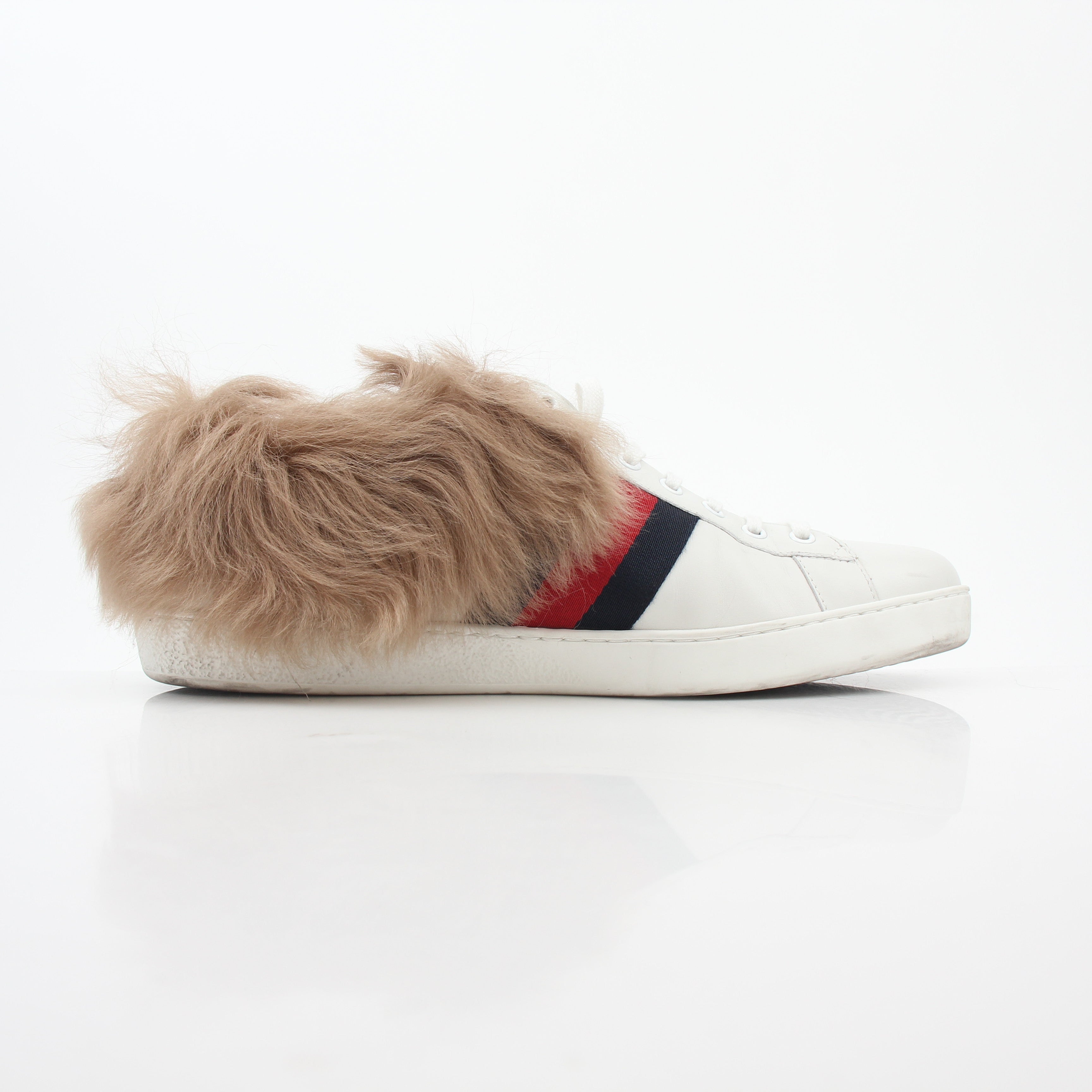 Gucci white Ace embroidered bee fur low-top sneakers featuring detailed bee embroidery and plush fur accents.