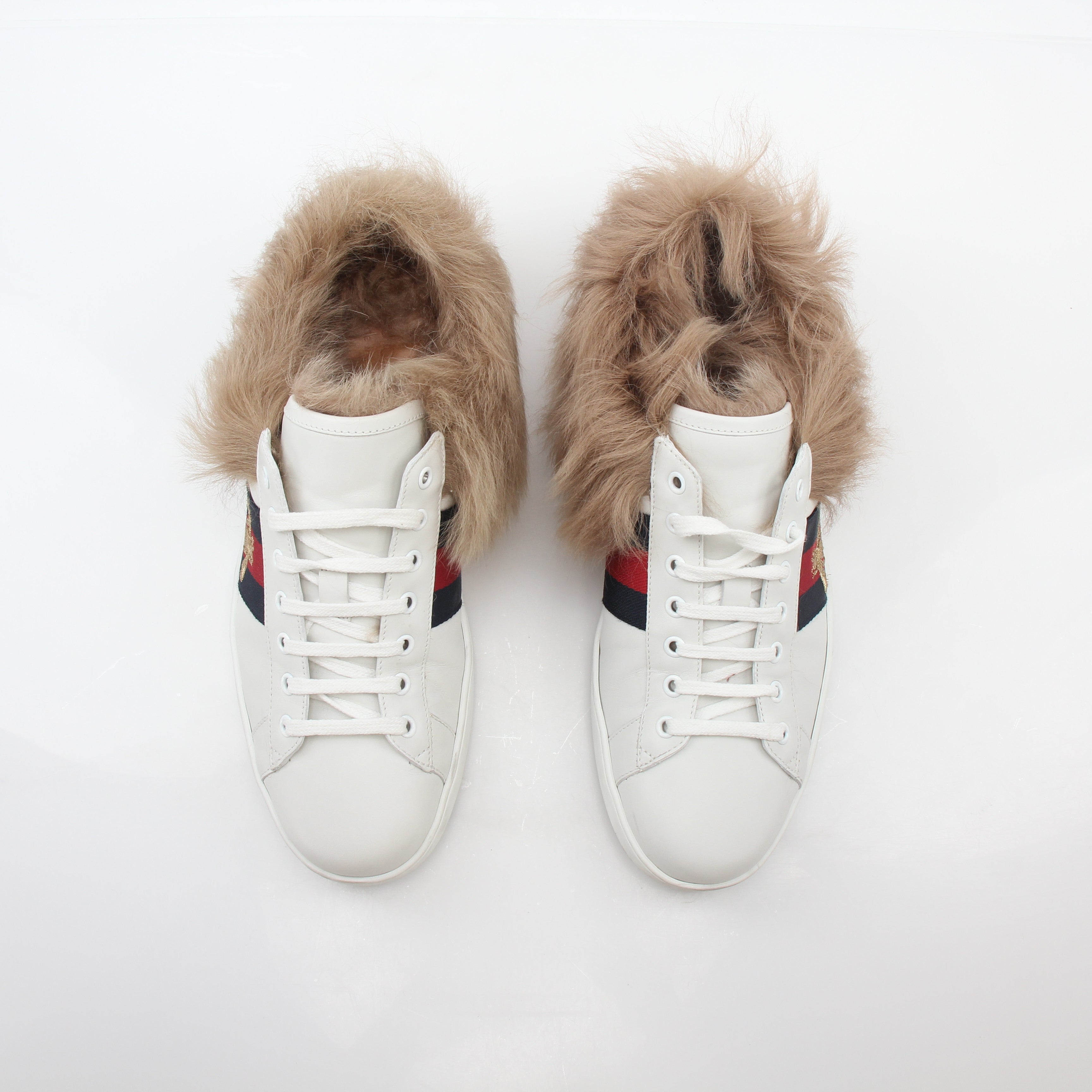 Gucci White Ace embroidered bee fur low-top sneakers with gold accents, stylish shoes featuring detailed embroidery and plush fur.