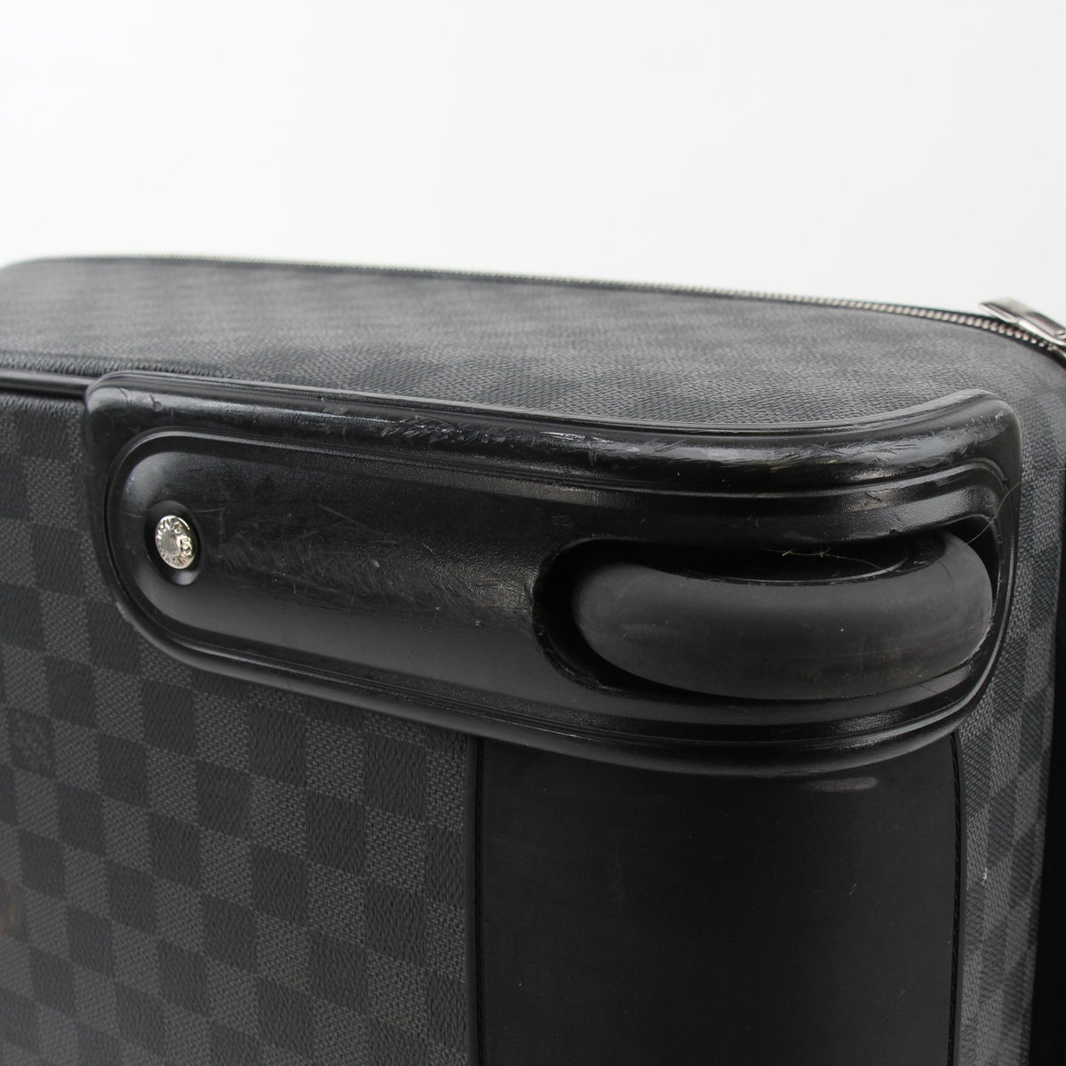 Louis Vuitton Damier Graphite Pégase 45 rolling luggage, black checkered travel bag with extendable handle and wheels.