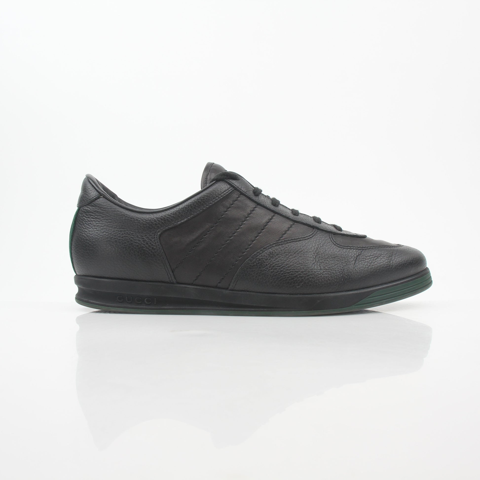 Gold & Beyond black Gucci Tennis 1984 low-top sneakers with sleek leather design and classic lace-up closure.