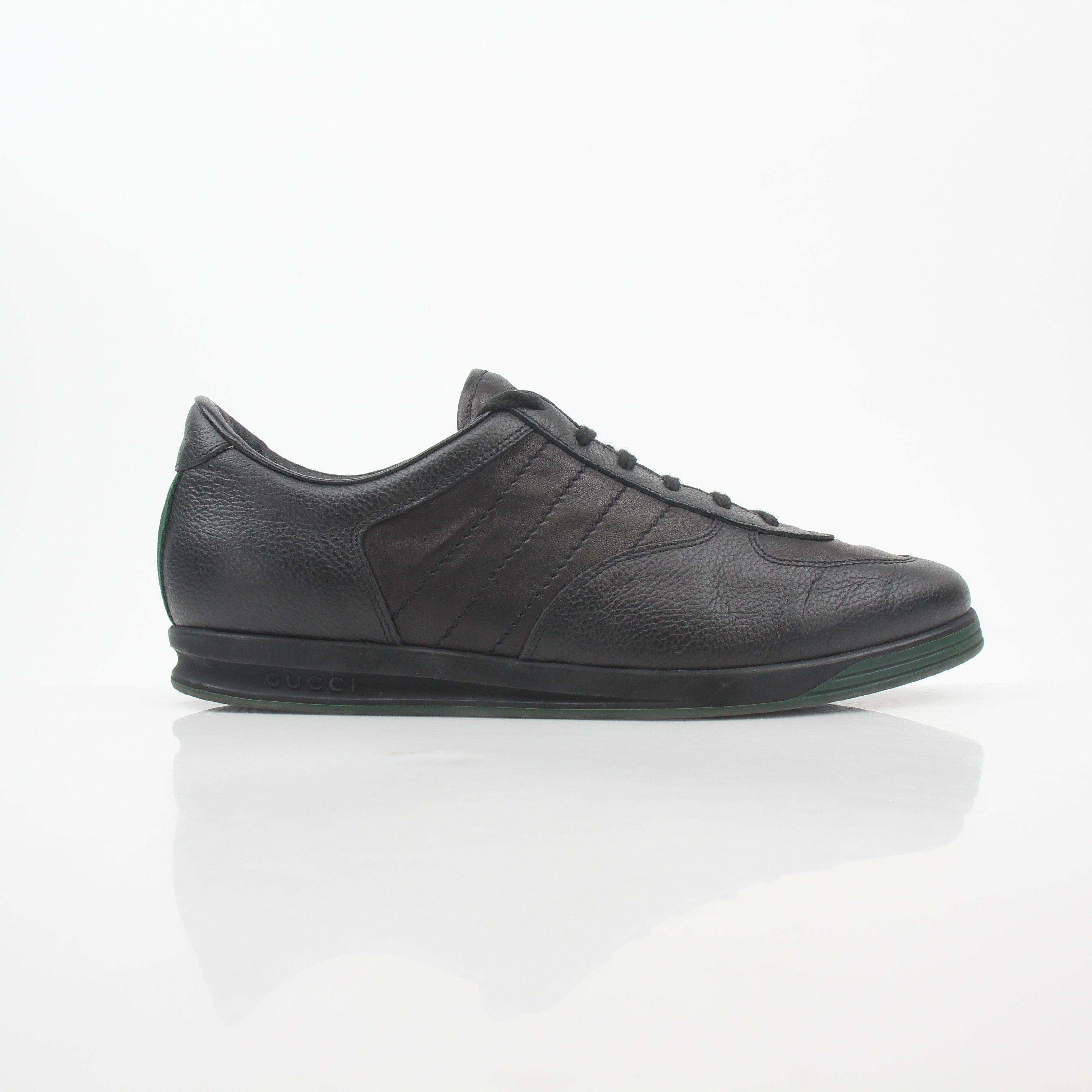 Gold & Beyond black Gucci Tennis 1984 low-top sneakers with sleek leather design and classic lace-up closure.