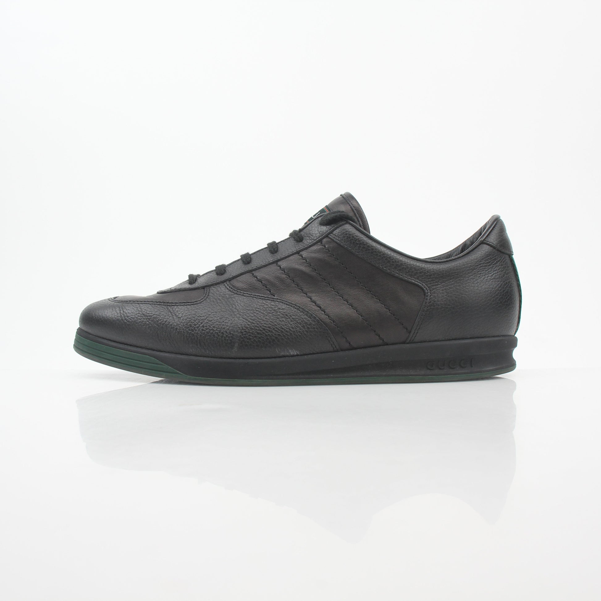 Gold & Beyond Gucci Black Tennis 1984 Low-Top Sneakers, stylish shoes featuring a sleek black design and classic low-top silhouette.