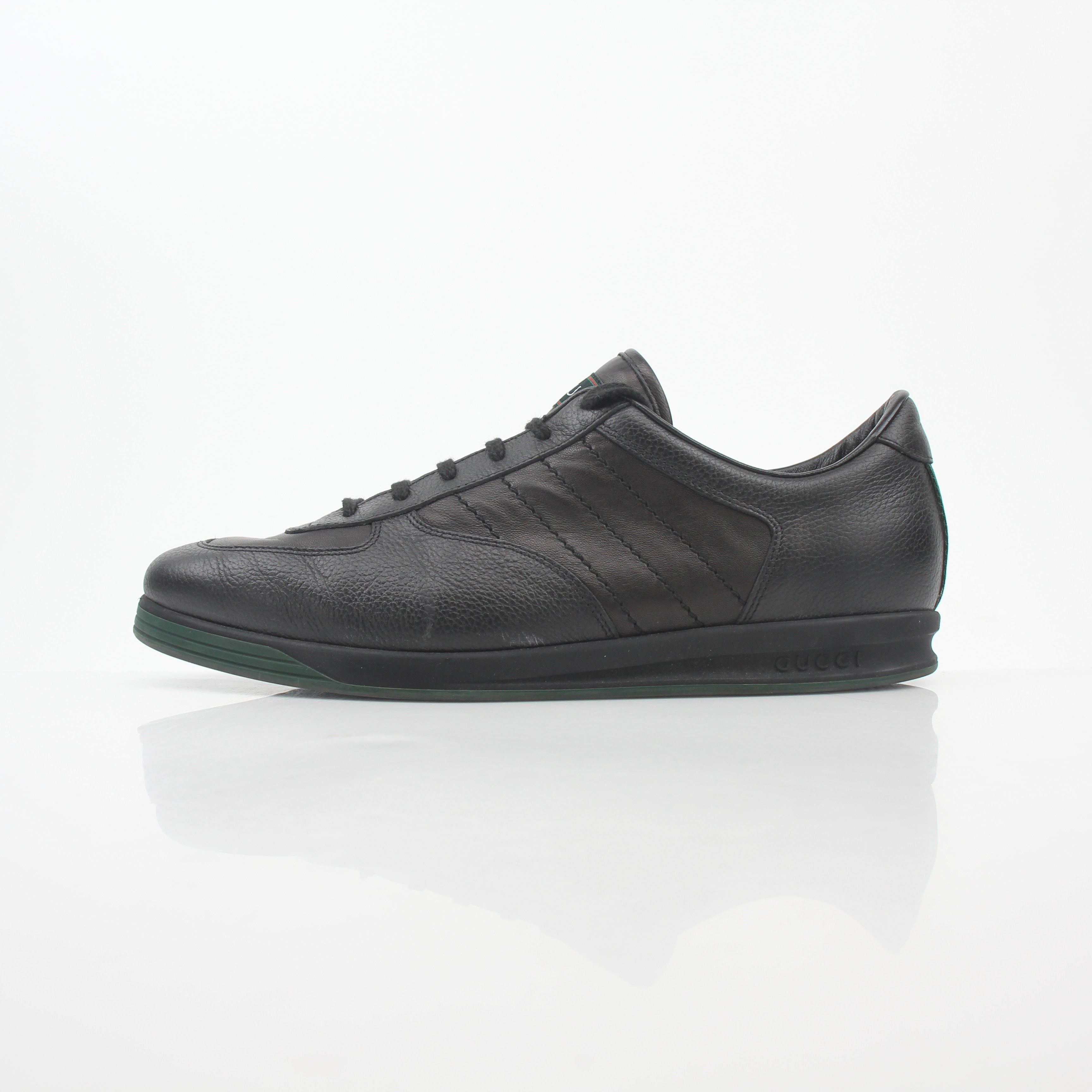 Gold & Beyond Gucci Black Tennis 1984 Low-Top Sneakers, stylish shoes featuring a sleek black design and classic low-top silhouette.