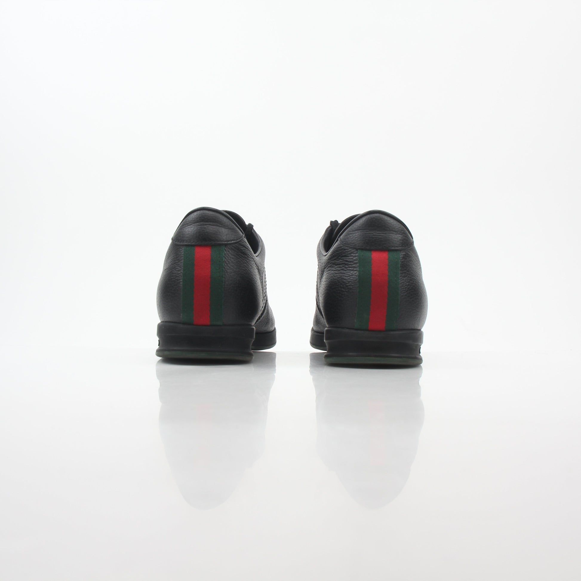 Gold & Beyond Gucci Black Tennis 1984 Low-Top Sneakers, stylish shoes with a sleek black design and classic low-top silhouette.