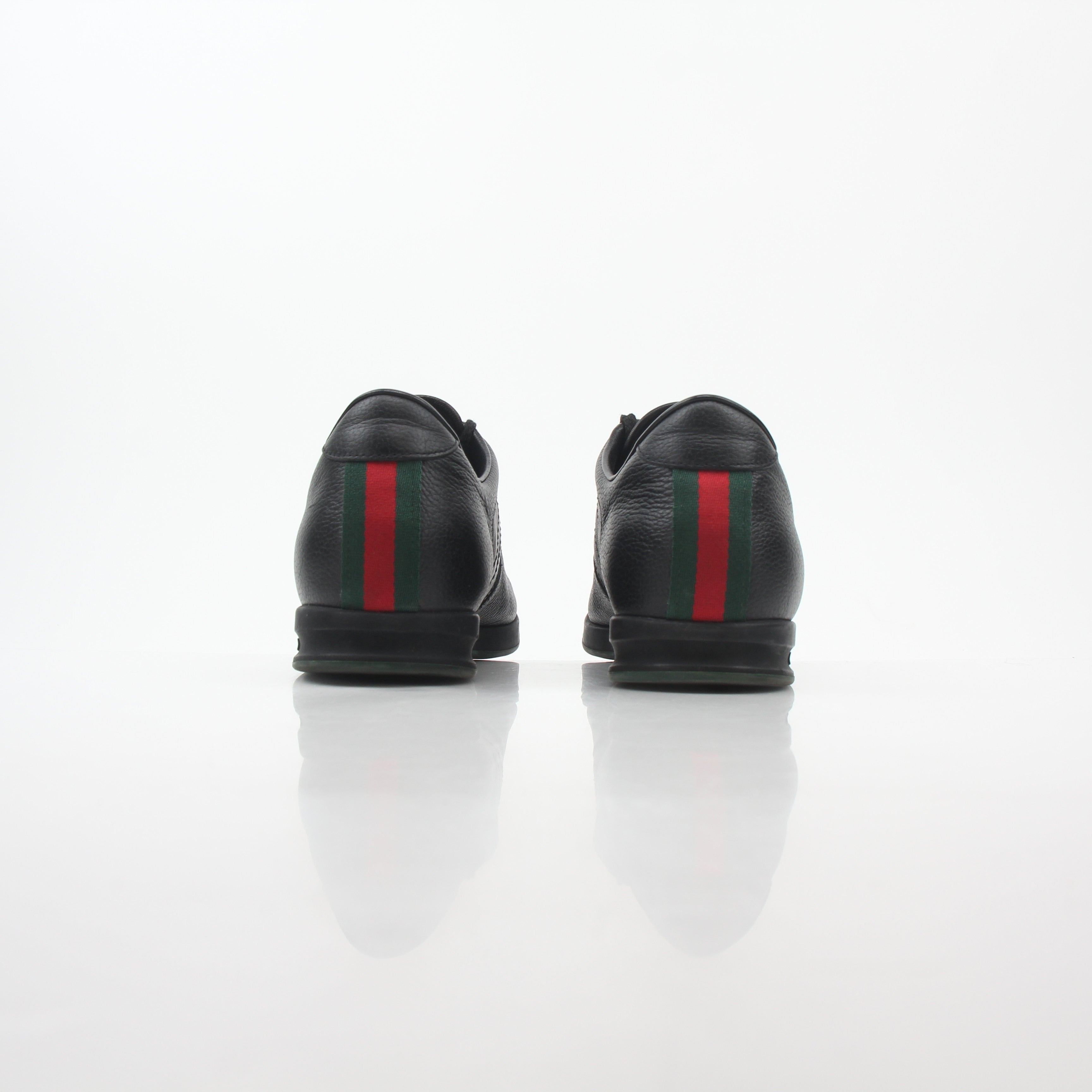 Gold & Beyond Gucci Black Tennis 1984 Low-Top Sneakers, stylish shoes with a sleek black design and classic low-top silhouette.