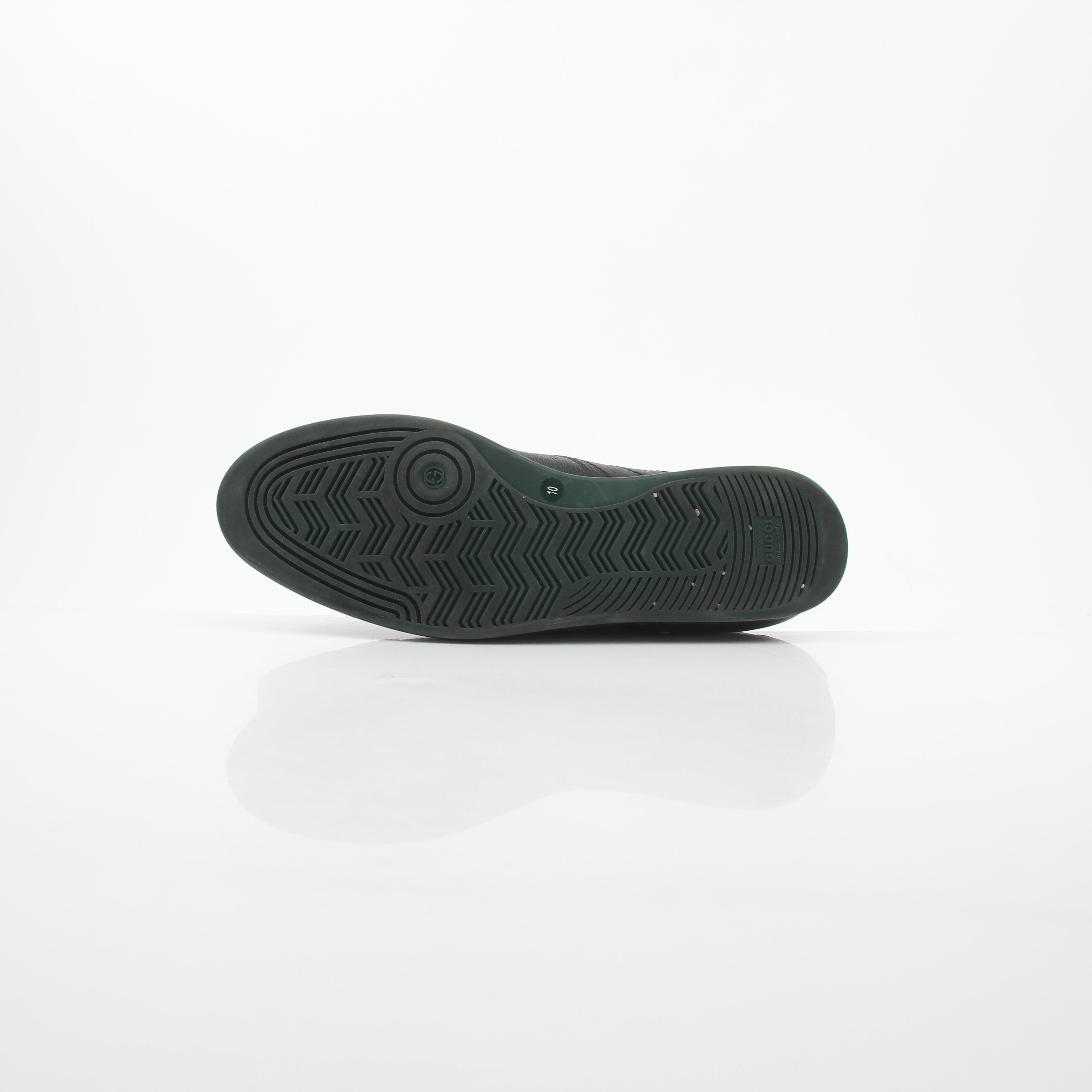 Gold & Beyond Gucci Black Tennis 1984 low-top sneakers with white rubber soles and classic Gucci logo detail.