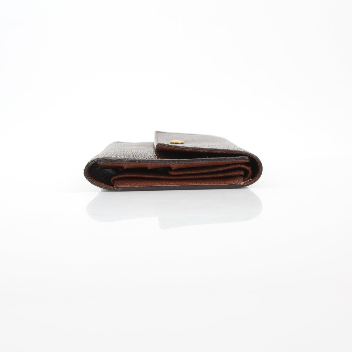 Louis Vuitton brown monogram portefeuille international wallet with gold accents, featuring multiple card slots and a secure zip closure.