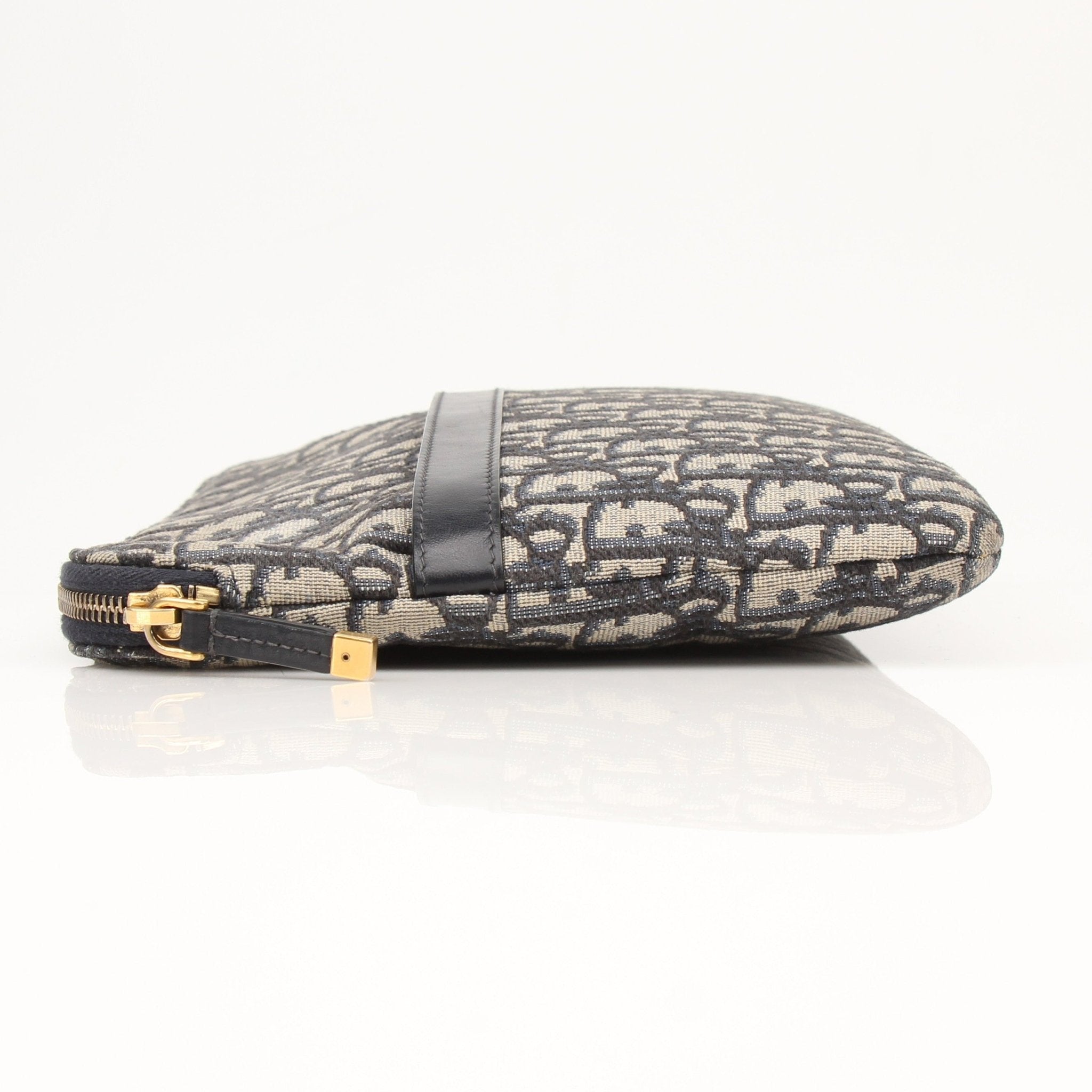 Christian Dior Oblique canvas pouch handbag with gold-tone details and zipper closure, featuring the signature Dior monogram pattern.