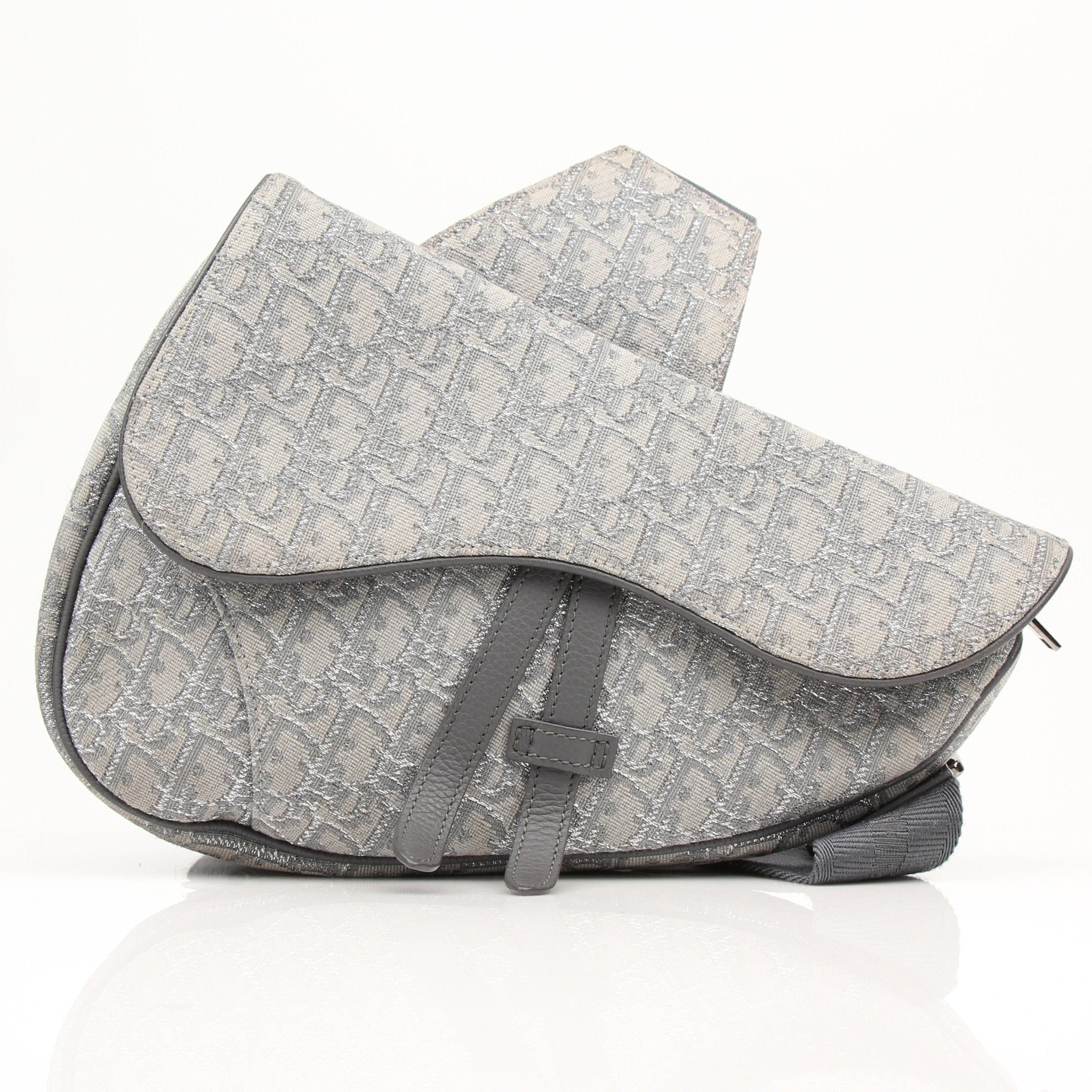 Christian Dior Oblique Saddle Bag handbag with gold hardware and adjustable strap, showcasing the iconic monogram pattern.