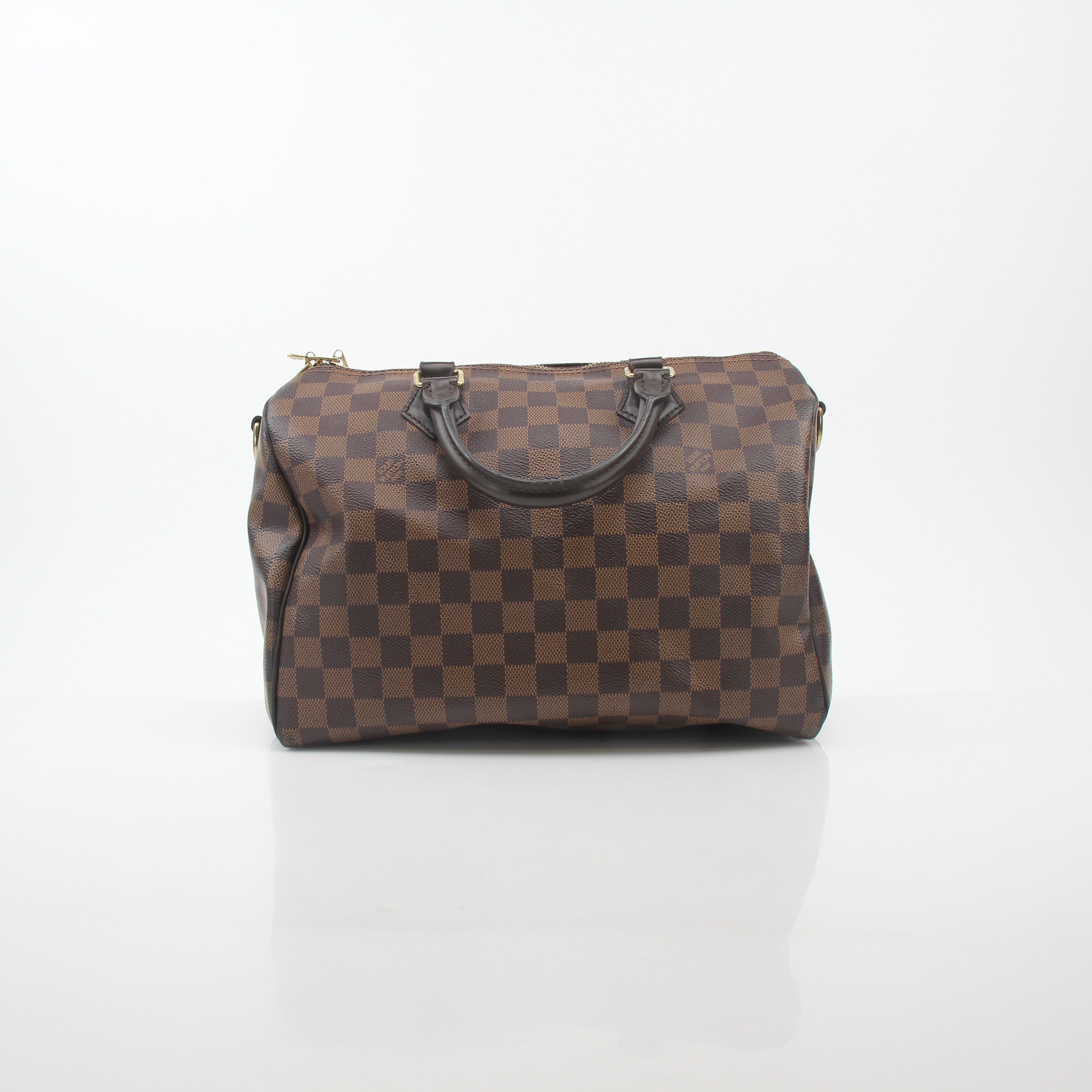 Louis Vuitton Damier Ebene Speedy Bandoulière 30 handbag with leather handles and gold-tone hardware, featuring signature checkered pattern.