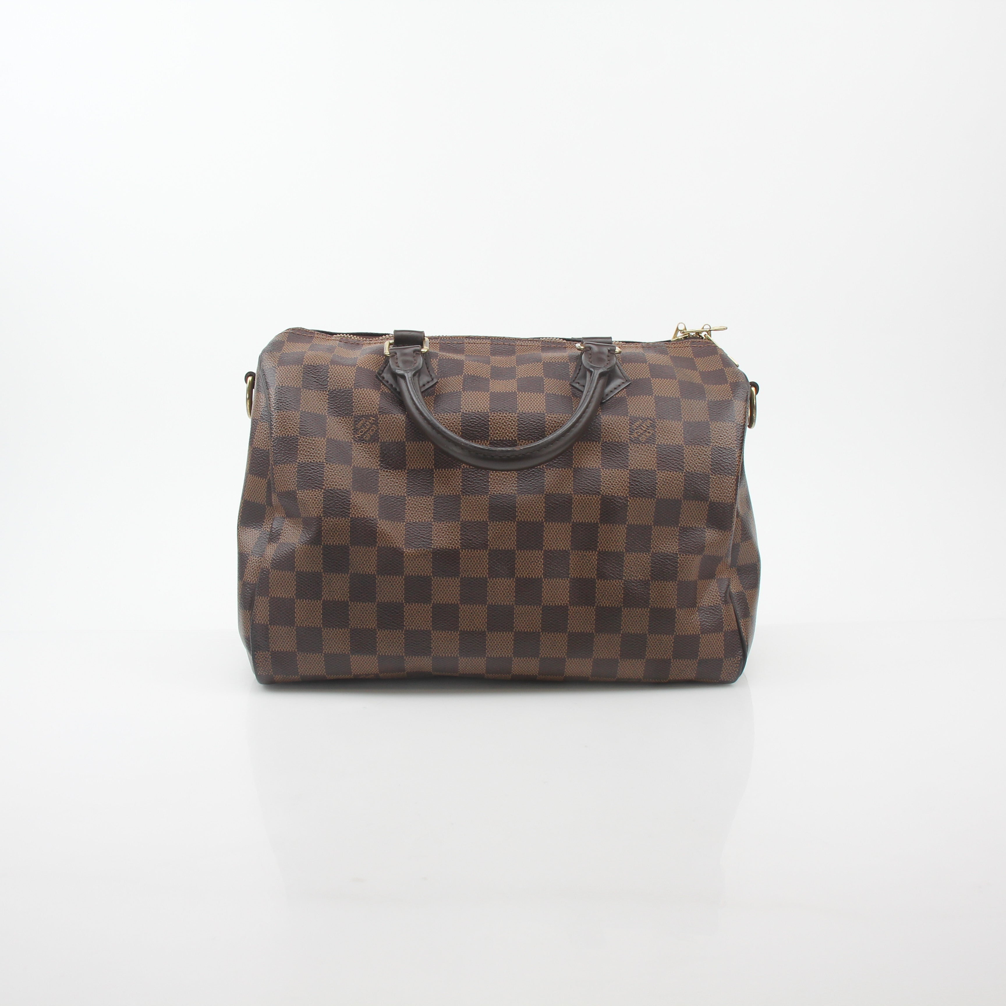 Louis Vuitton Damier Ebene Speedy Bandoulière 30 handbag with leather trim and gold hardware, displayed on a plain background.