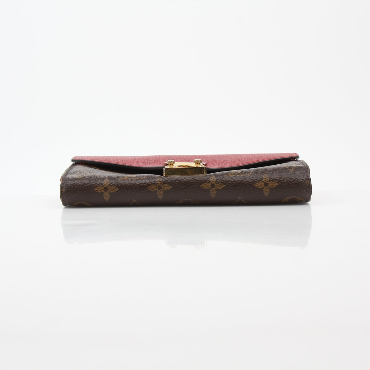 Louis Vuitton brown monogram Pallas wallet with red interior, compact design, and gold hardware, by Gold & Beyond.
