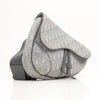 Christian Dior Saddle Bag in grey oblique canvas, showcasing iconic silhouette and elegant handbag design by Gold & Beyond.