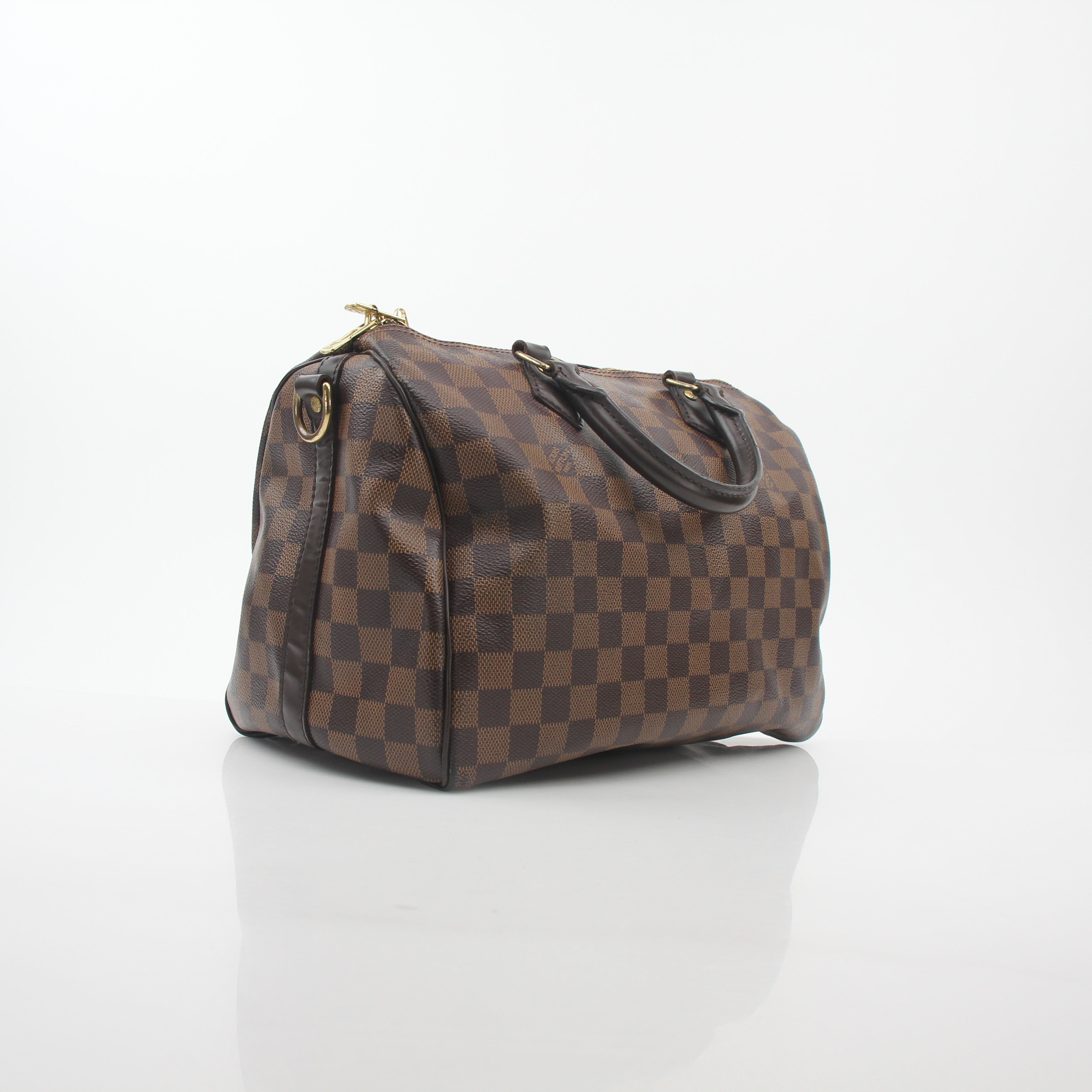 Louis Vuitton Damier Ebene Speedy Bandoulière 30 handbag with leather handles and signature checkered pattern.