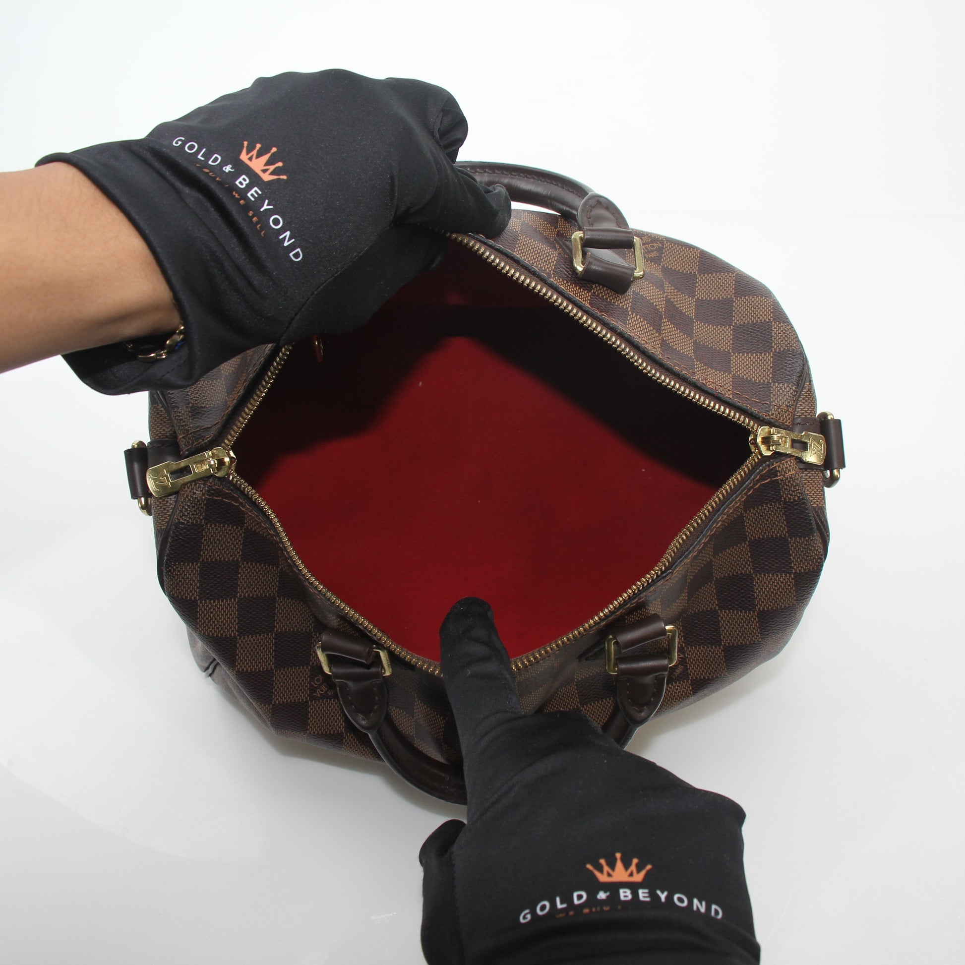 Louis Vuitton Damier Ebene Speedy Bandoulière 30 handbag with leather handles and gold hardware, featuring the signature checkered pattern.