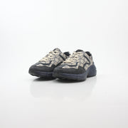 Gucci Rhyton GG Supreme Canvas Sneakers with white rubber soles and gold accents, displayed on a plain background.