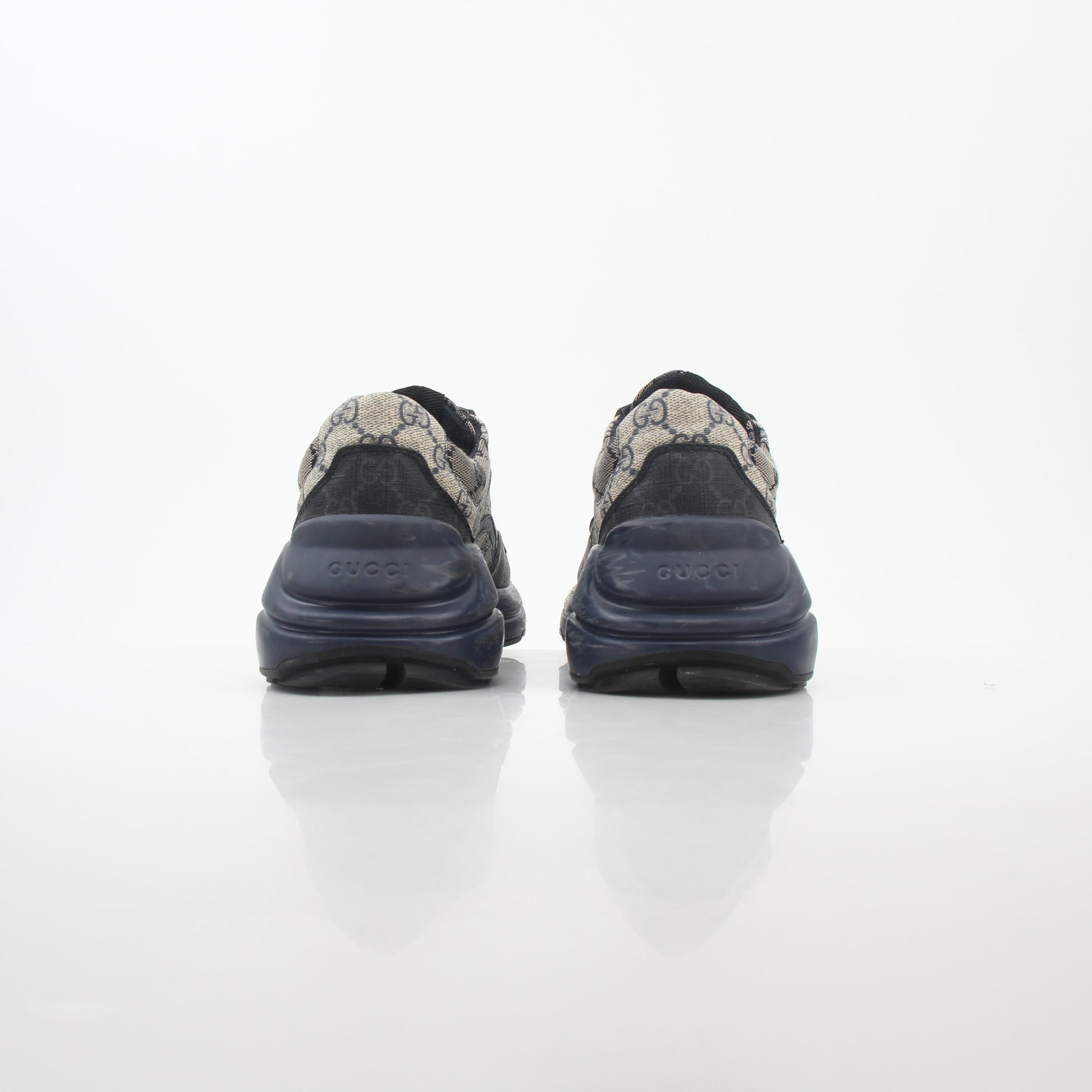 Gucci Rhyton GG Supreme Canvas Sneakers featuring beige and brown monogram pattern with white rubber soles and lace-up design.