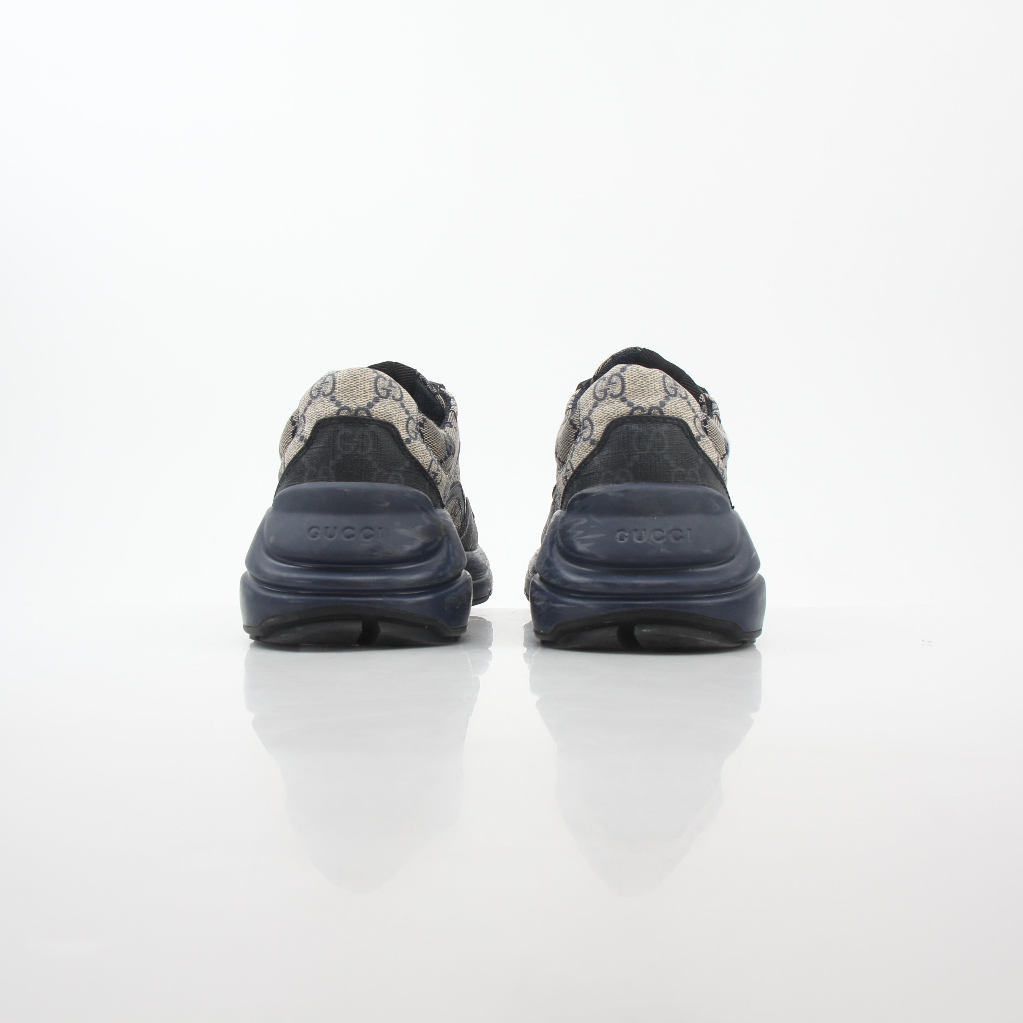 Gucci Rhyton GG Supreme Canvas Sneakers featuring beige and brown monogram pattern with white rubber soles and lace-up design.