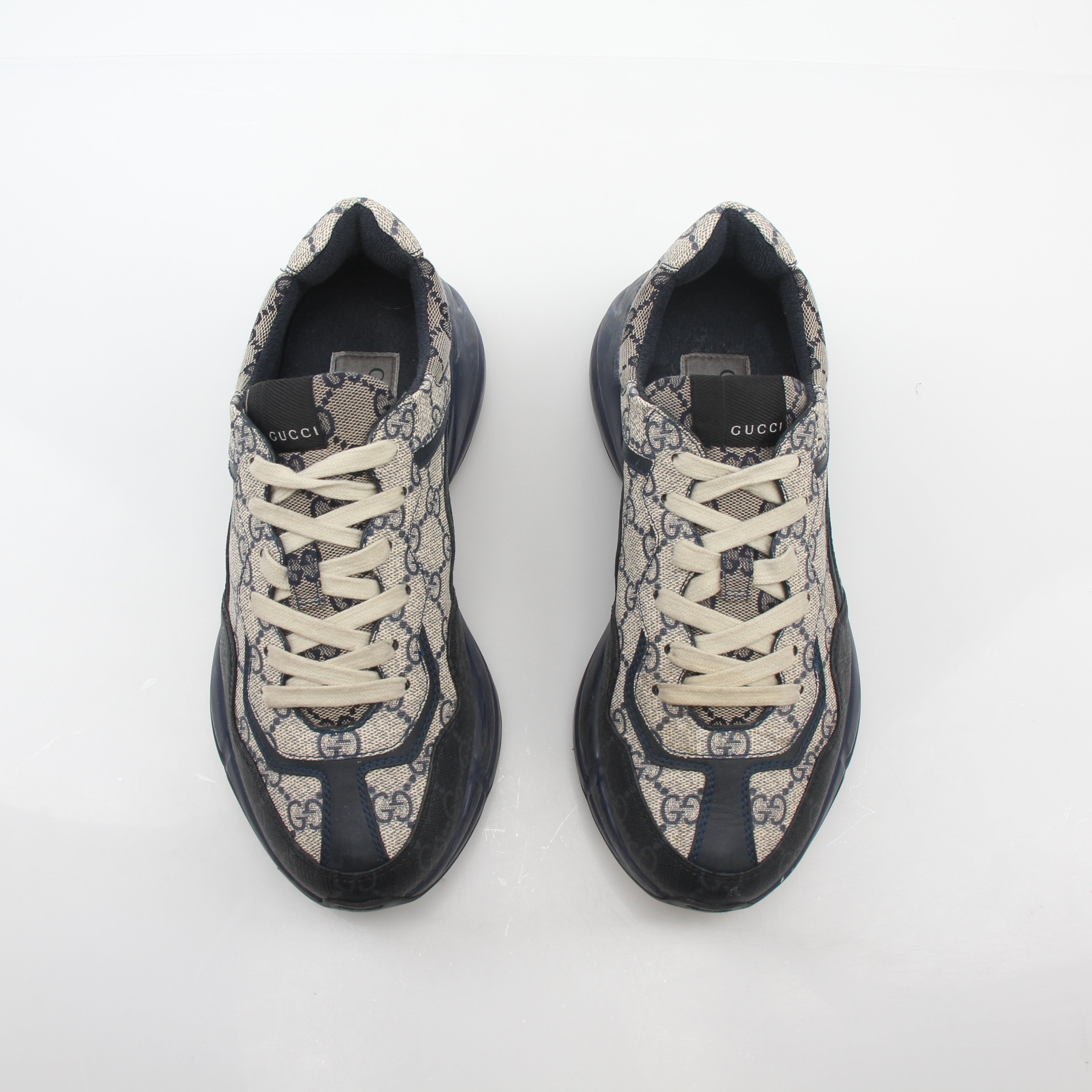 Gucci Rhyton GG Supreme Canvas Sneakers showing the stylish design and brand logo on the shoes' side.