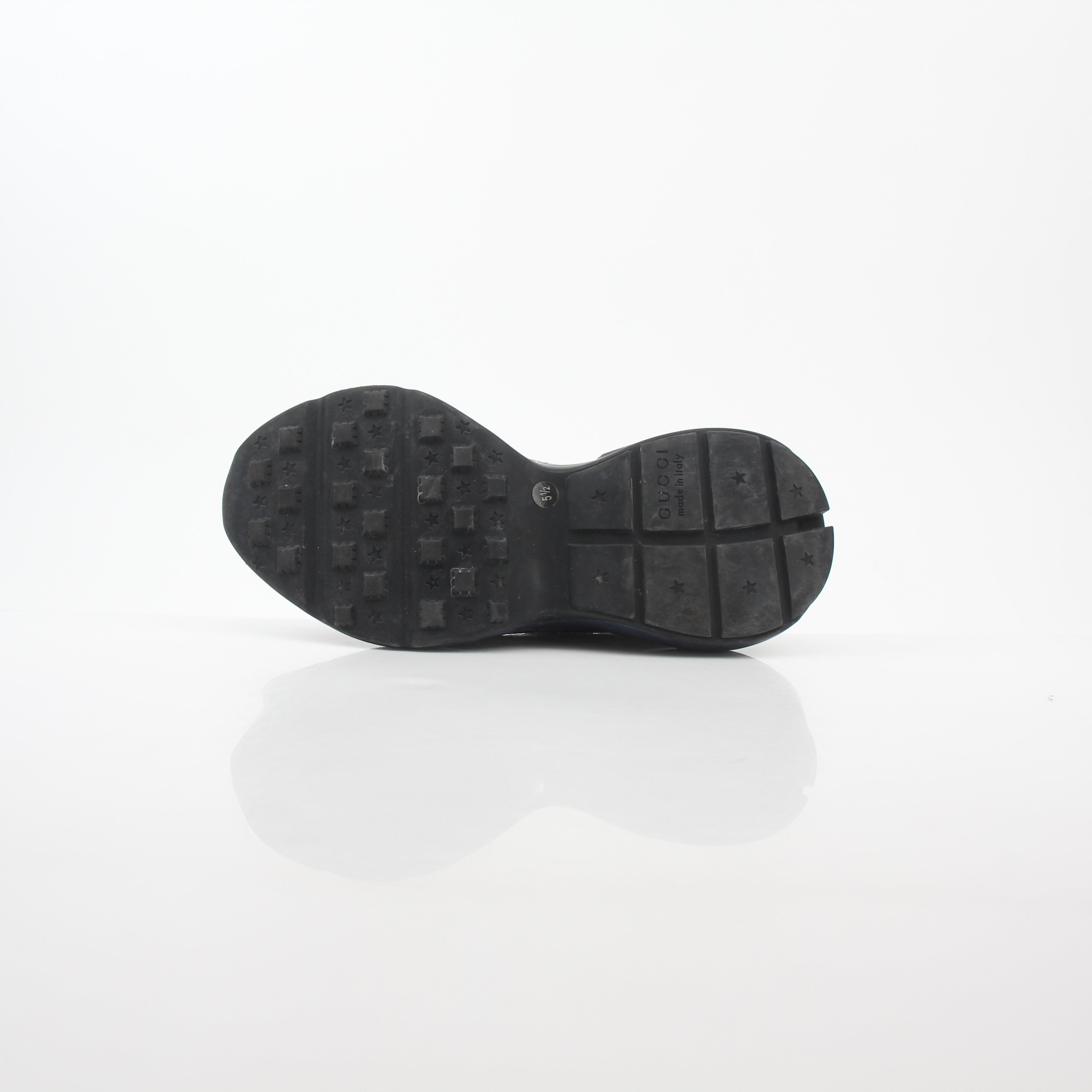 Gucci Rhyton GG Supreme Canvas sneakers with white rubber soles and gold accents, featuring the iconic GG pattern and stylish design.