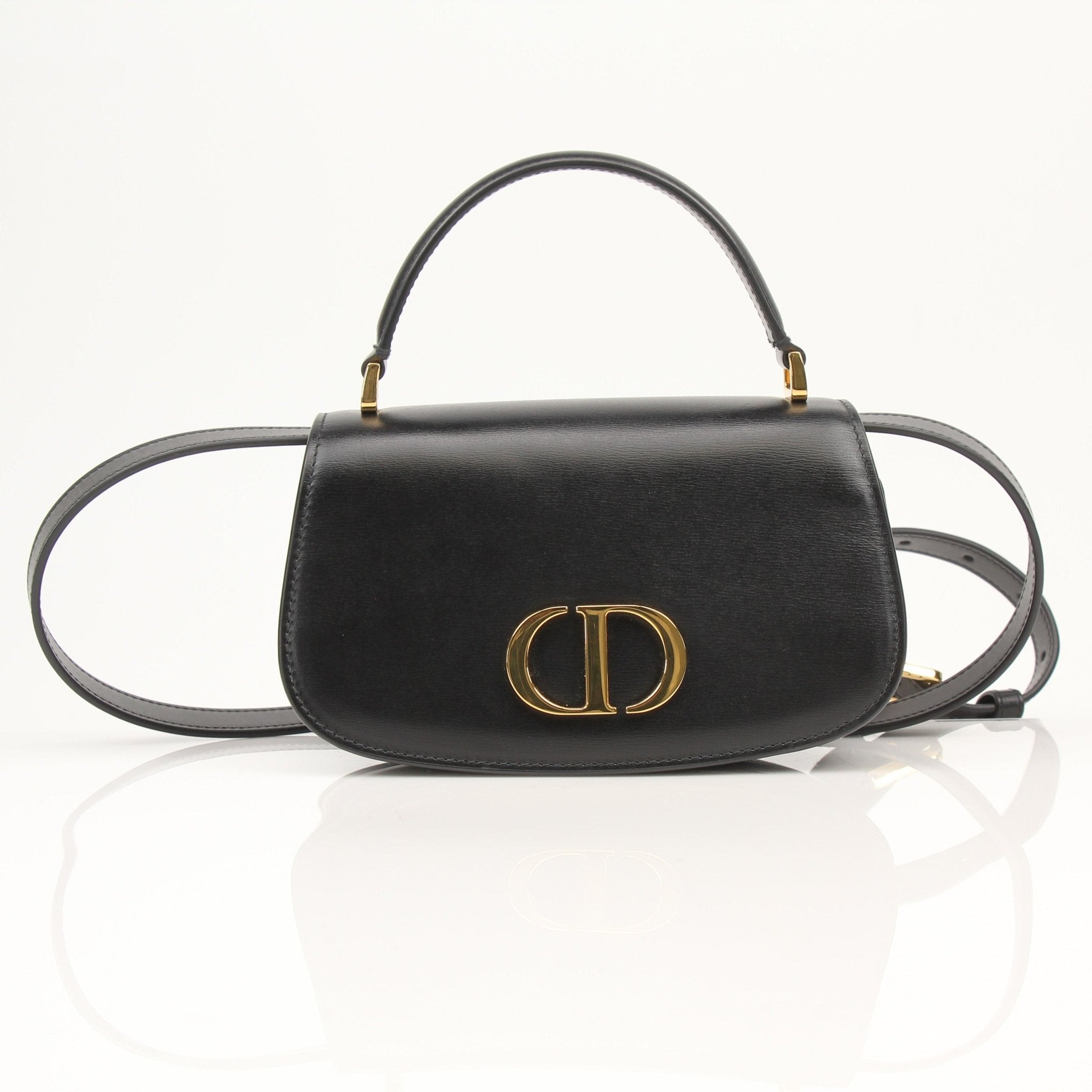 Christian Dior 30 Montaigne Avenue handbag with top handle and gold hardware, featuring elegant design and high-quality leather.