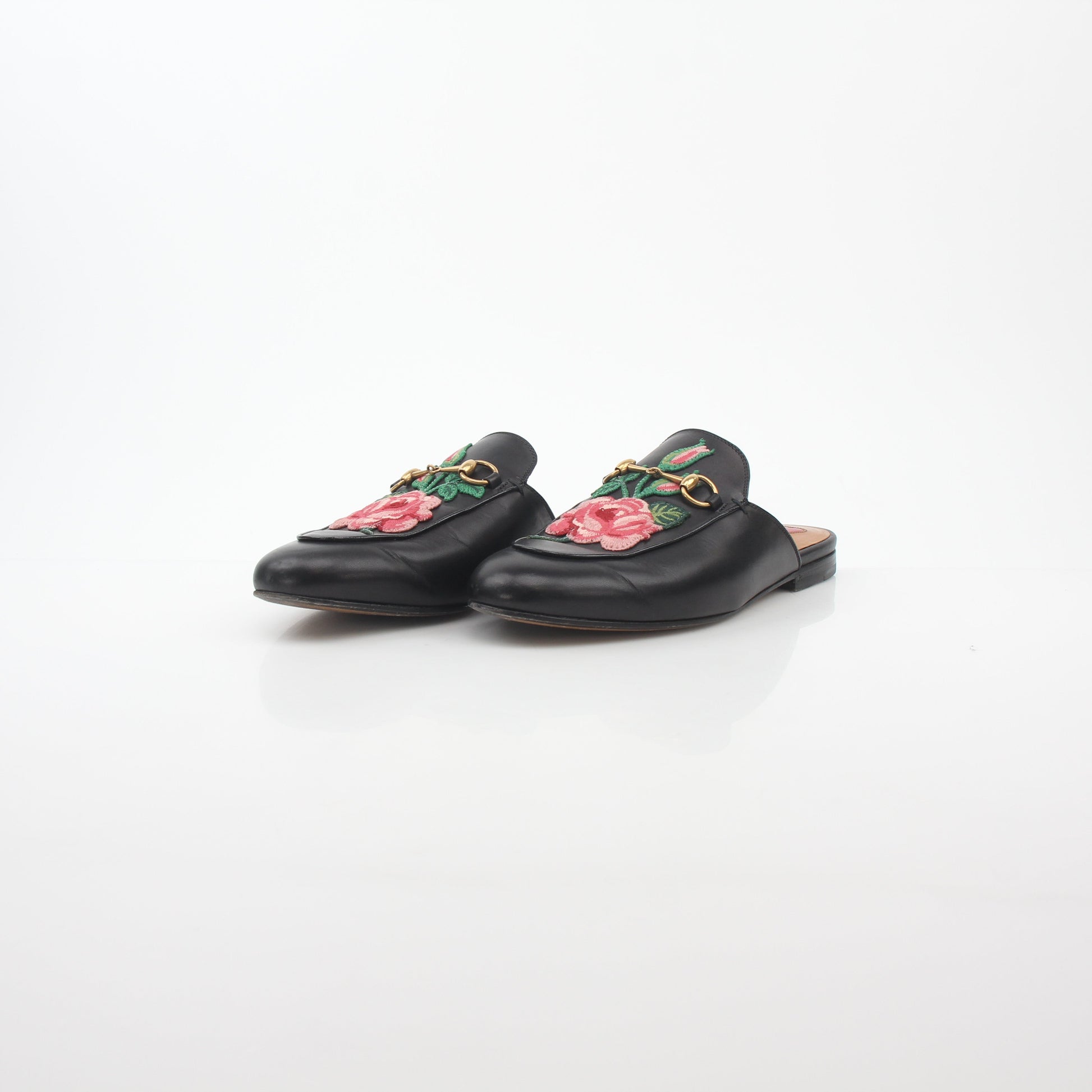 Gold & Beyond Gucci black Princetown leather mule with rose embroidery, stylish slip-on shoes for women.